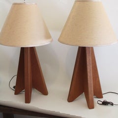Pair of architectural origami teak tripod lamps, 1970s