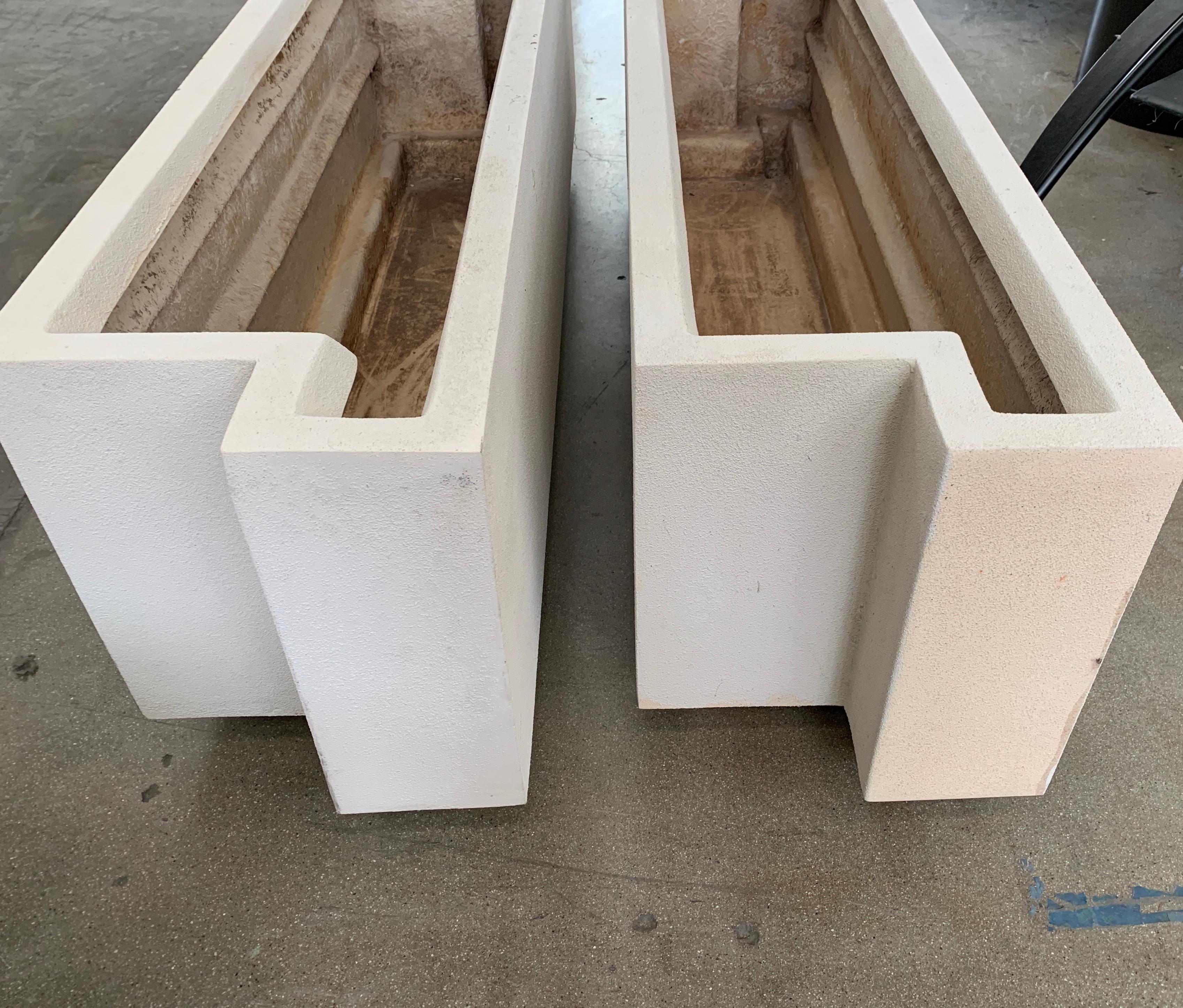A nice pair of architectural outdoor planters. These are made of fiberglass and each have two drainage holes on one side. They have some age, and have minor losses and imperfections. There is some paint loss and chips, detailed in the photographs.