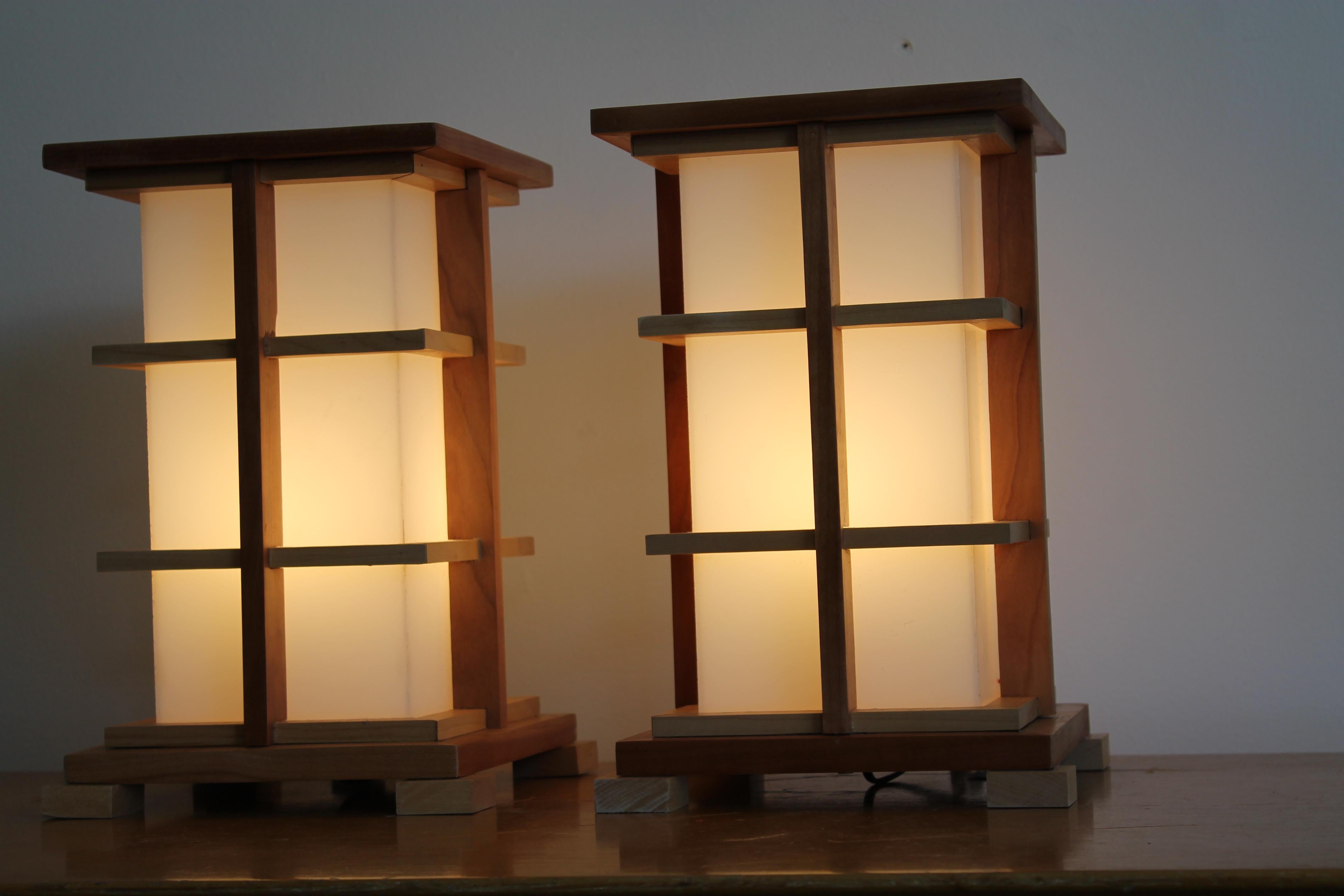 A matched pair of wood and Lucite table lamps, artisan made, one of a kind. Each lamp measures 13.5