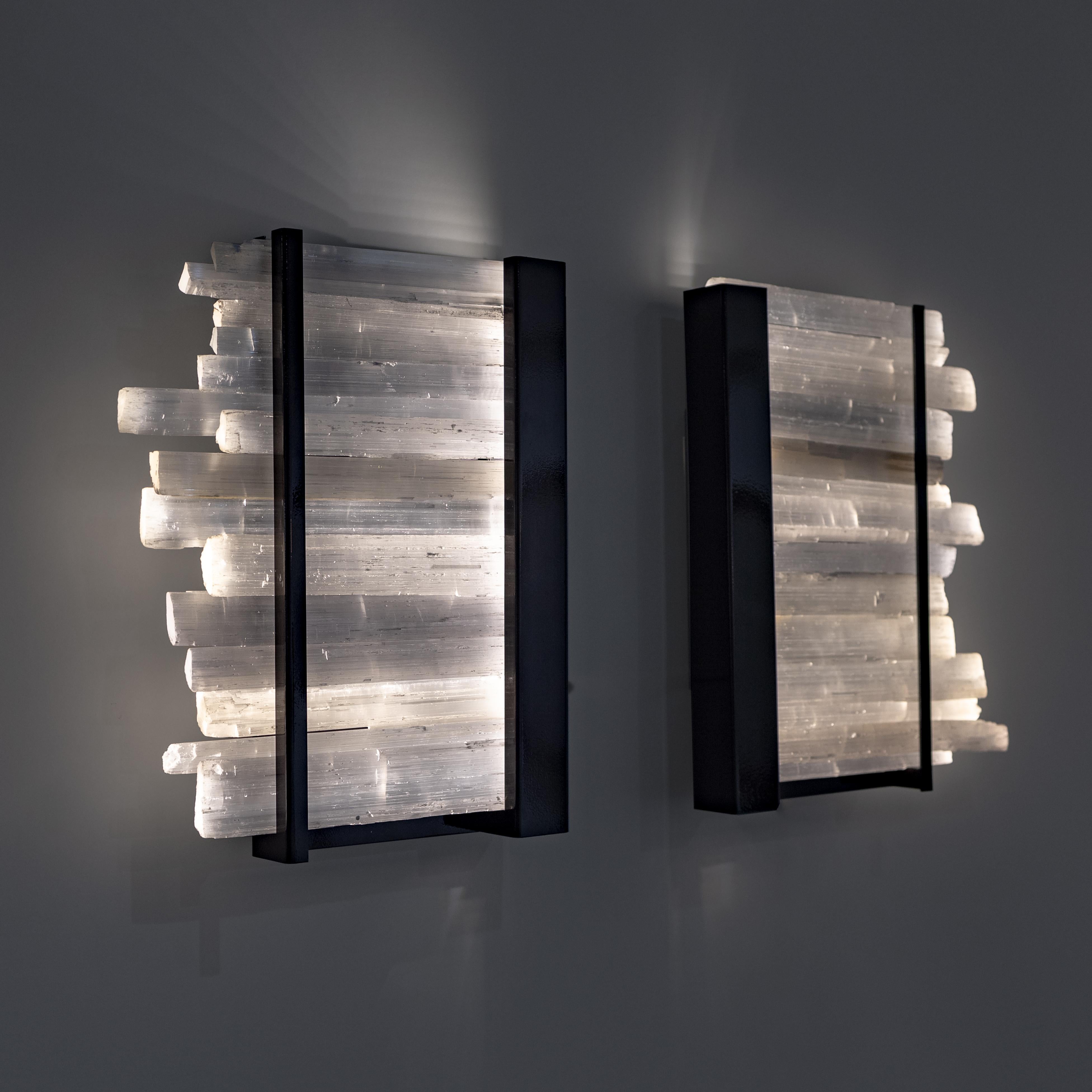 Arctic lighting Selenite crystal wall sconce with metal base
Selenite crystals from Morocco
Powder-coated metal base

These crystals are named after a Greek goddess of the moon, due to a legend of
Central Europe which tells that this