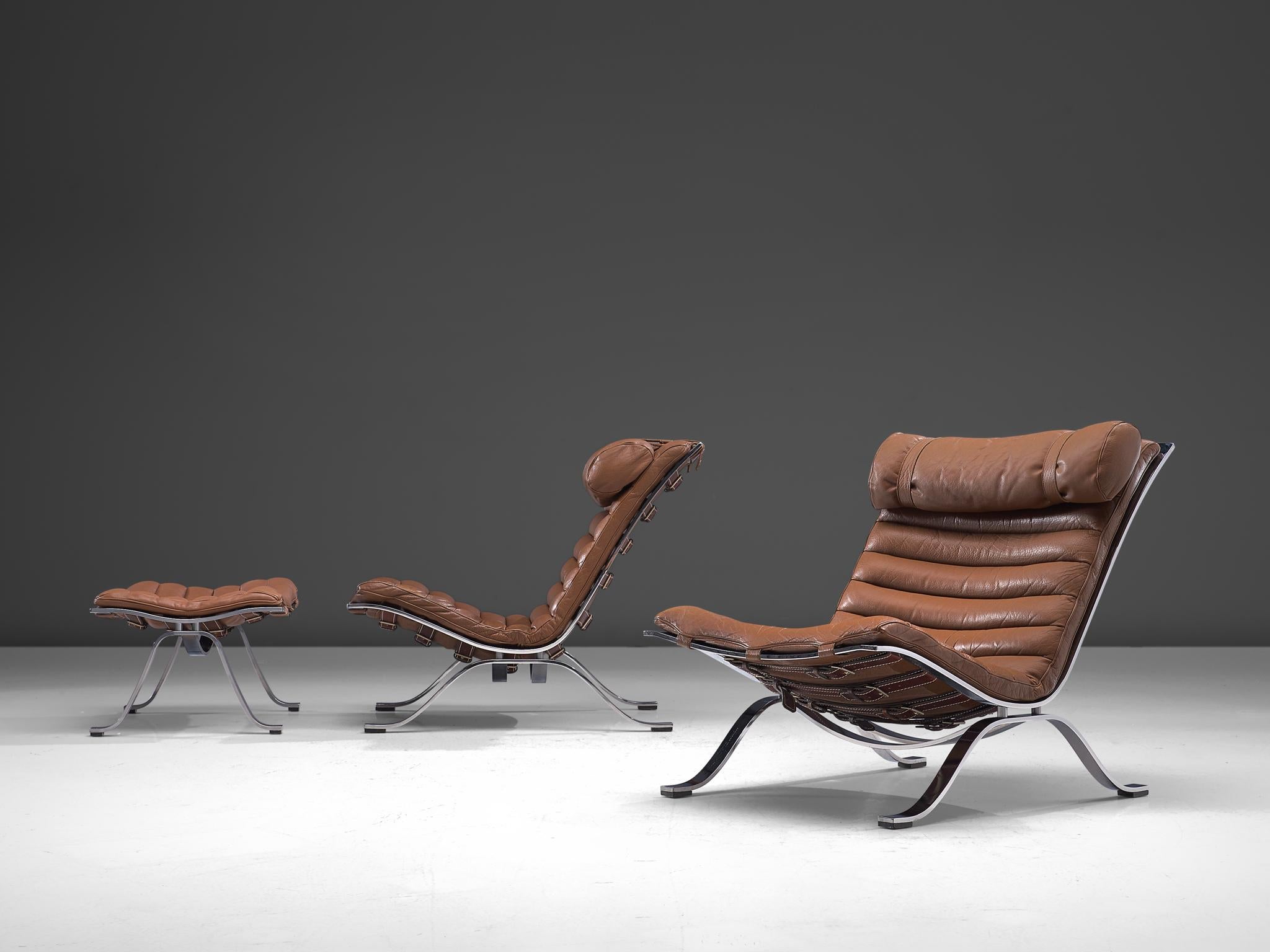 Arne Norell for Norell Møbel AB, pair 'Ari' lounge chairs with ottoman, brown leather, chrome-plated steel, Sweden, 1966. 

This pair of lounge chairs with pouf are designed by Arne Norell. The whole frame is executed in chrome-plated steel, and