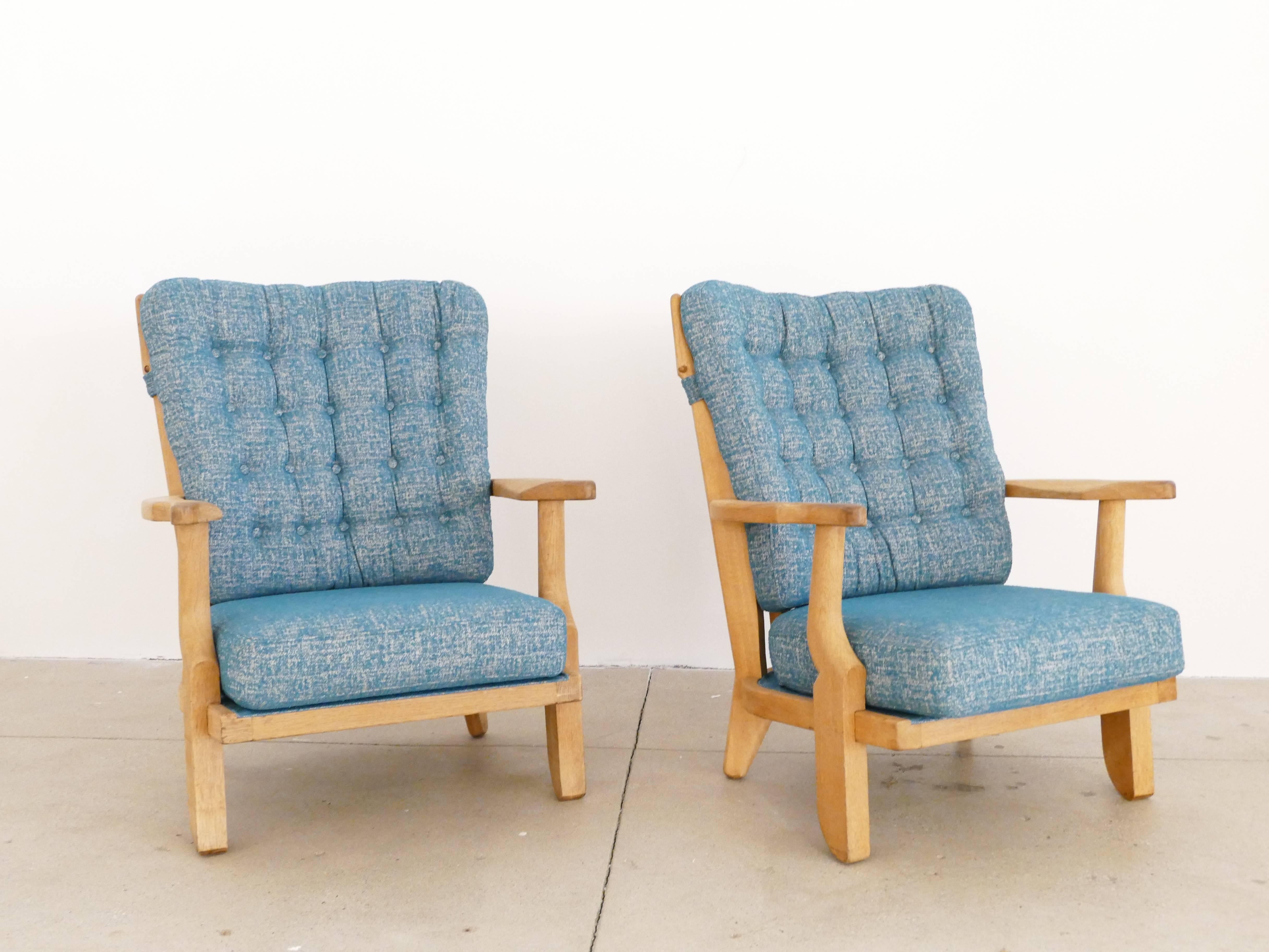 Two armchairs in excellent condition. The frame is solid, clean and in perfect condition. The new cushions have a teal colored cotton fabric reminiscent of the era of production. The spine work of the back are the signature of the artists. These