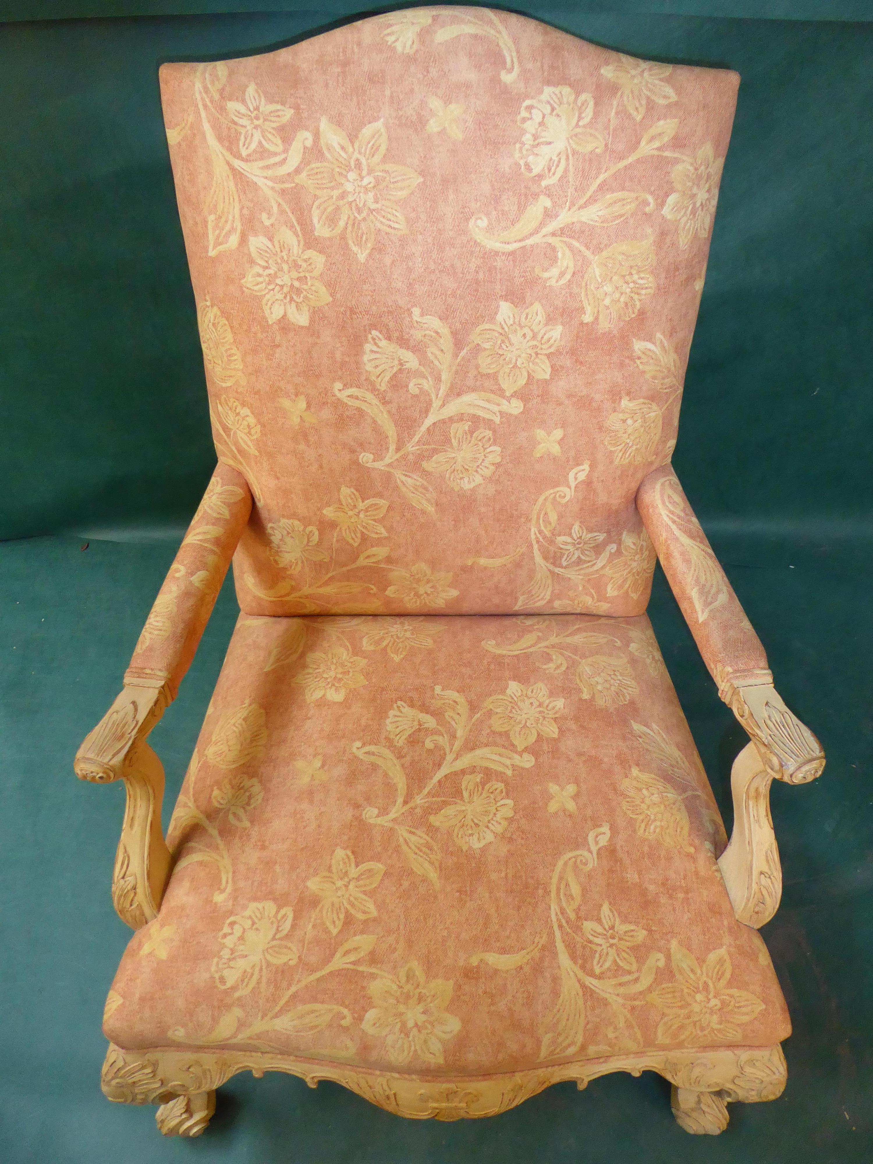 A pair of generous woood carved arm chairs.