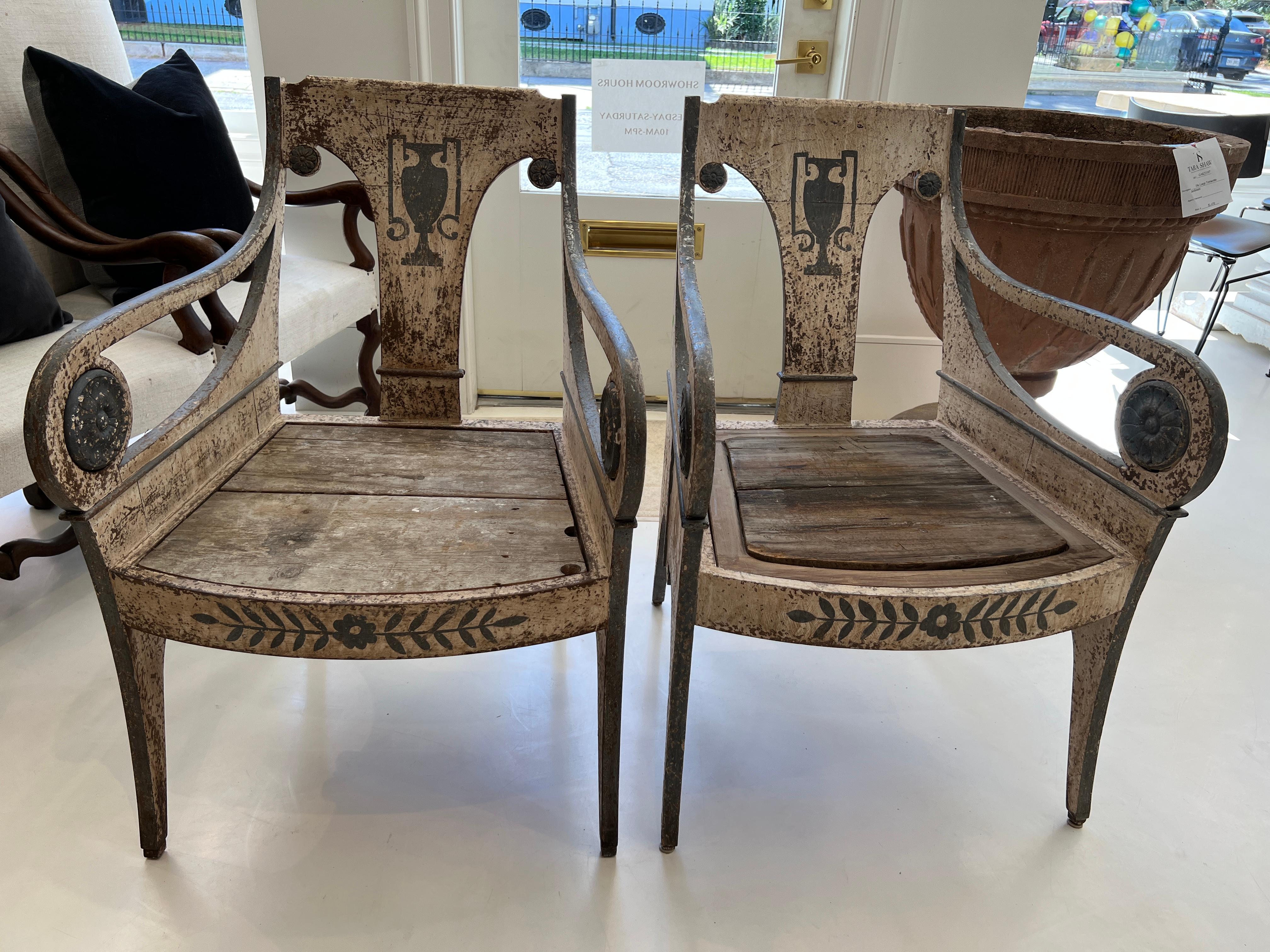 Beautifully designed wooden arm chairs with charming painted motif of urn on the back and leafy garland across the front apron. 

There are two sets of two chairs available.