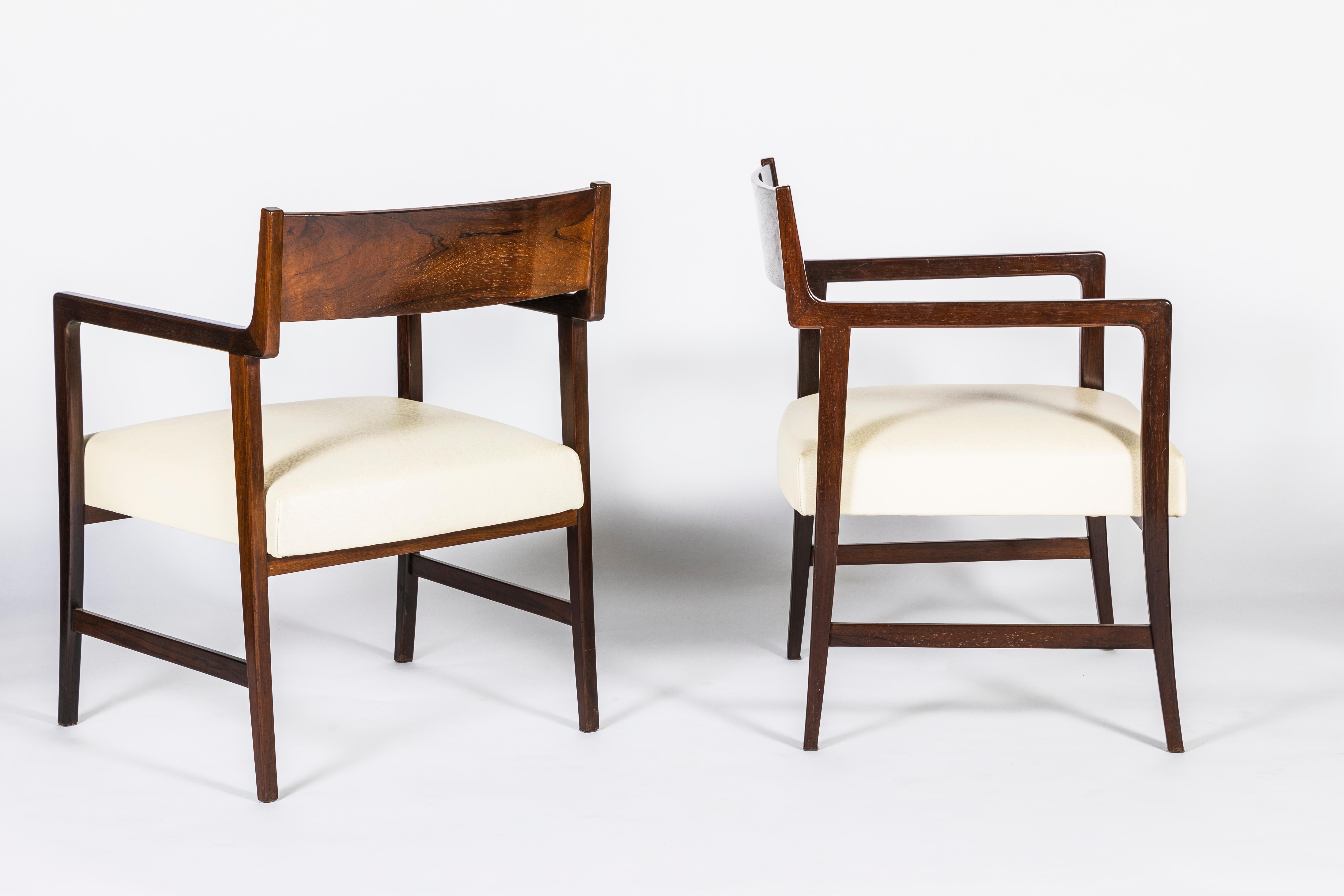 Pair of armchairs made of solid walnut from Joaquin Tenreiro, 1960
Sculpted wood with a great quality of wood: density and deep grain. 
Subtil and geometric curves inspired by the Danish Mid Century design with the large Brazilian dimensions. 
The