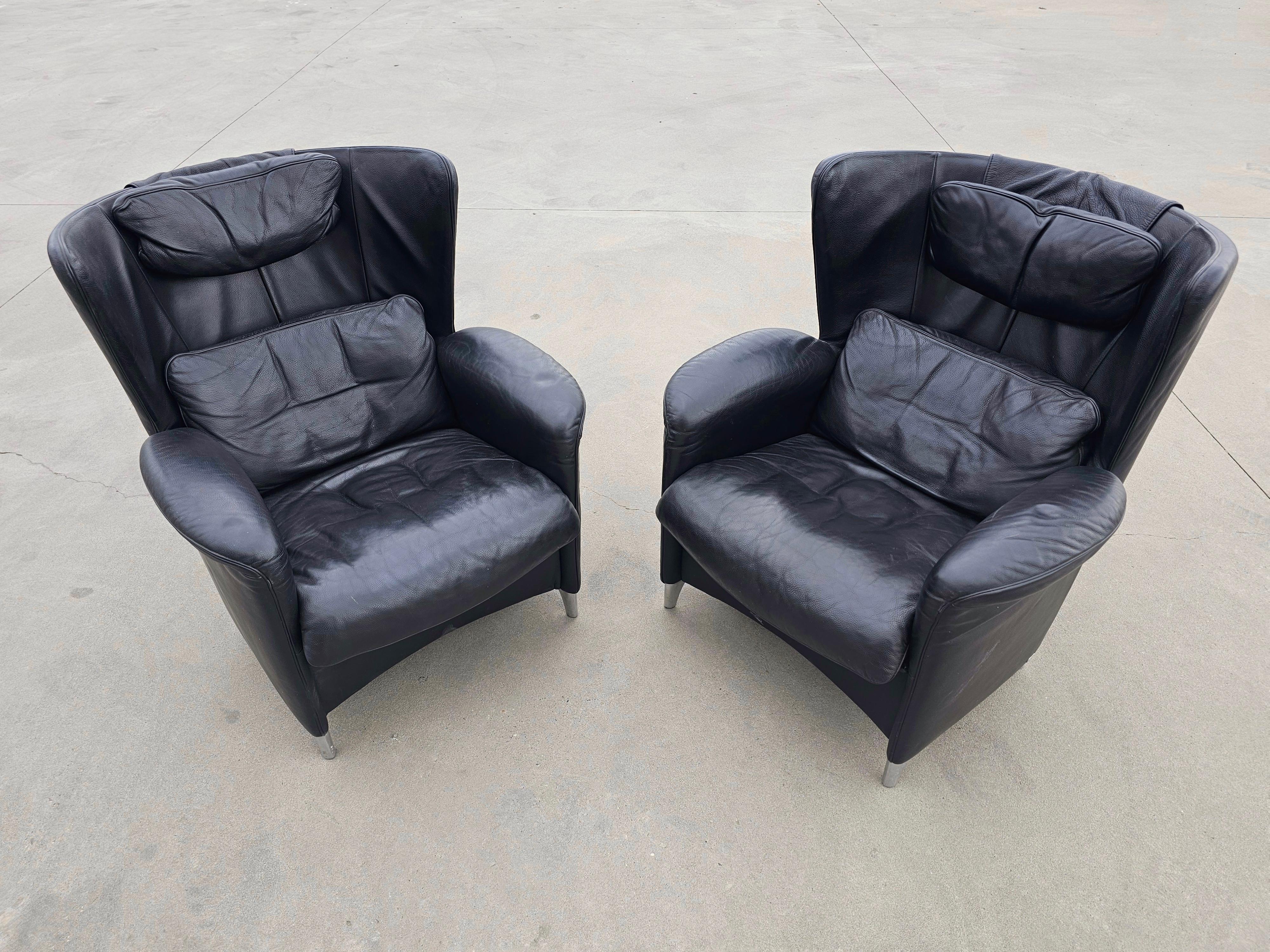 In this listing you will find a pair of rare Postmodern armchairs designed by Franz-Josef Schulte for De Sede. The armchair is known as the model DS-23 and are done in black leather. Manufacturer's label is present on upholstery bellow the leather