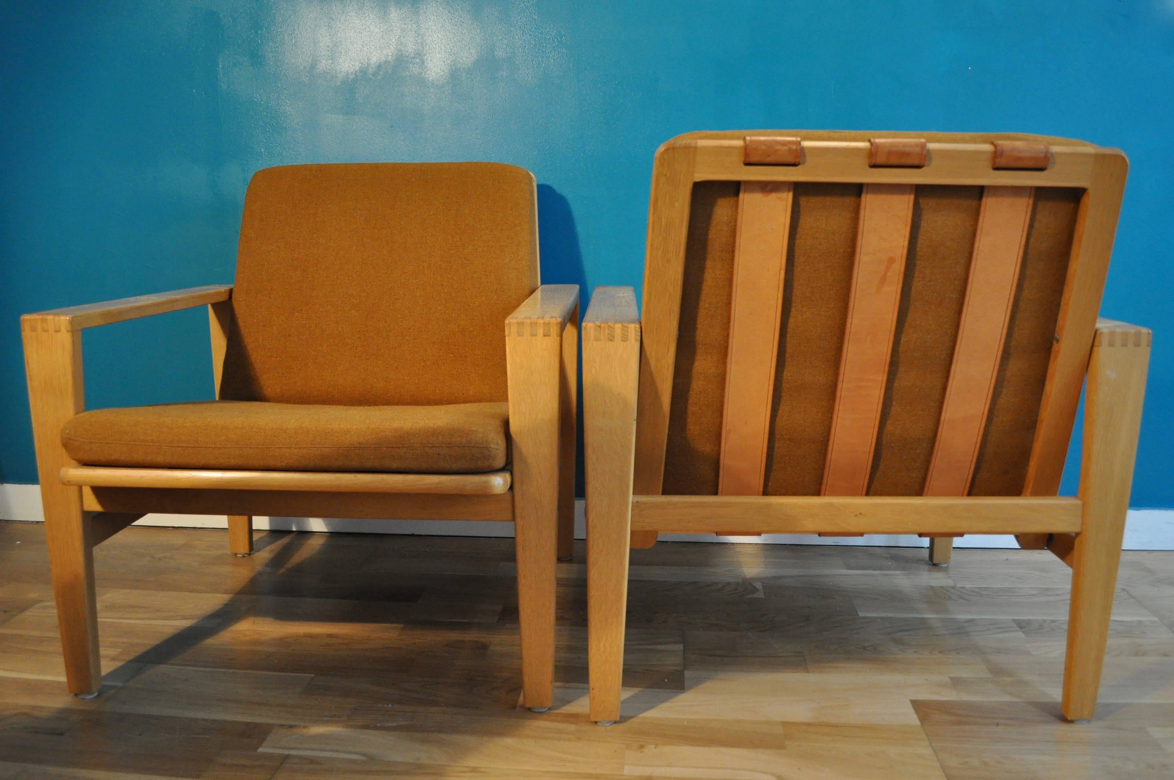 Impressive pair of armchair made in oak and leather structure designed by the swedish designer Eric Merthen, circa 1960. The fabric is in its orginal condition and can be replaced.

Can be ship disassembled for cheapest solution.
