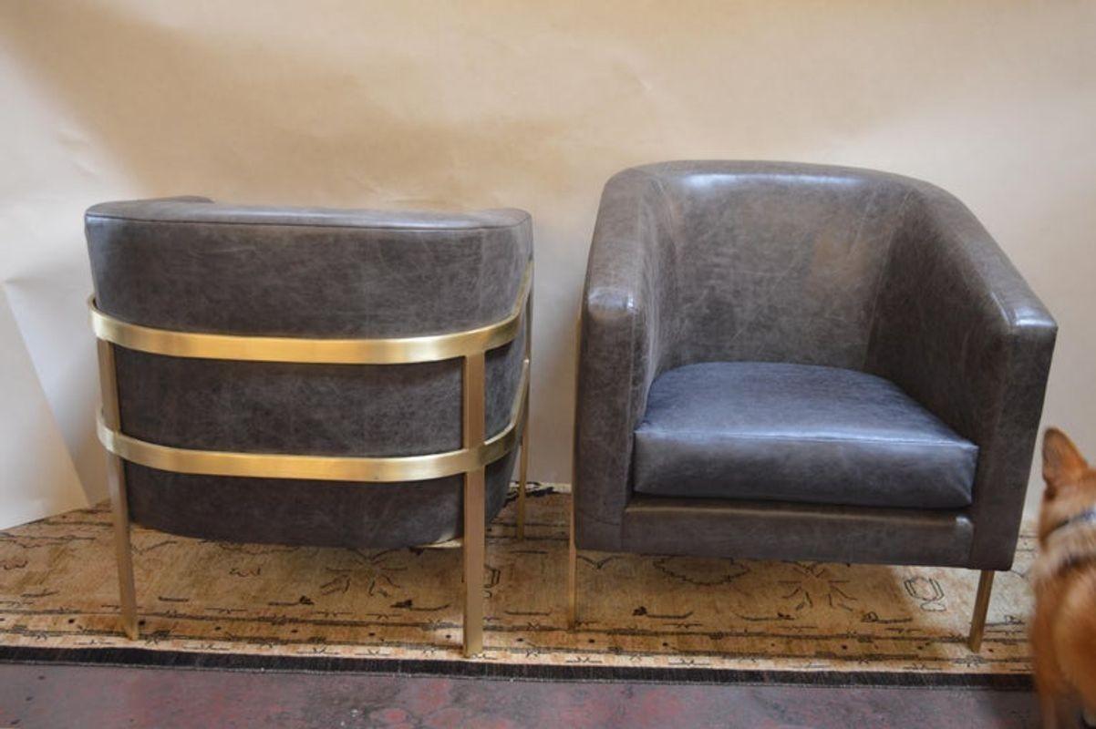 Two distressed grey leather armchairs with dark blue leather seats and polished brass frame. Attributed to Milo Baughman.