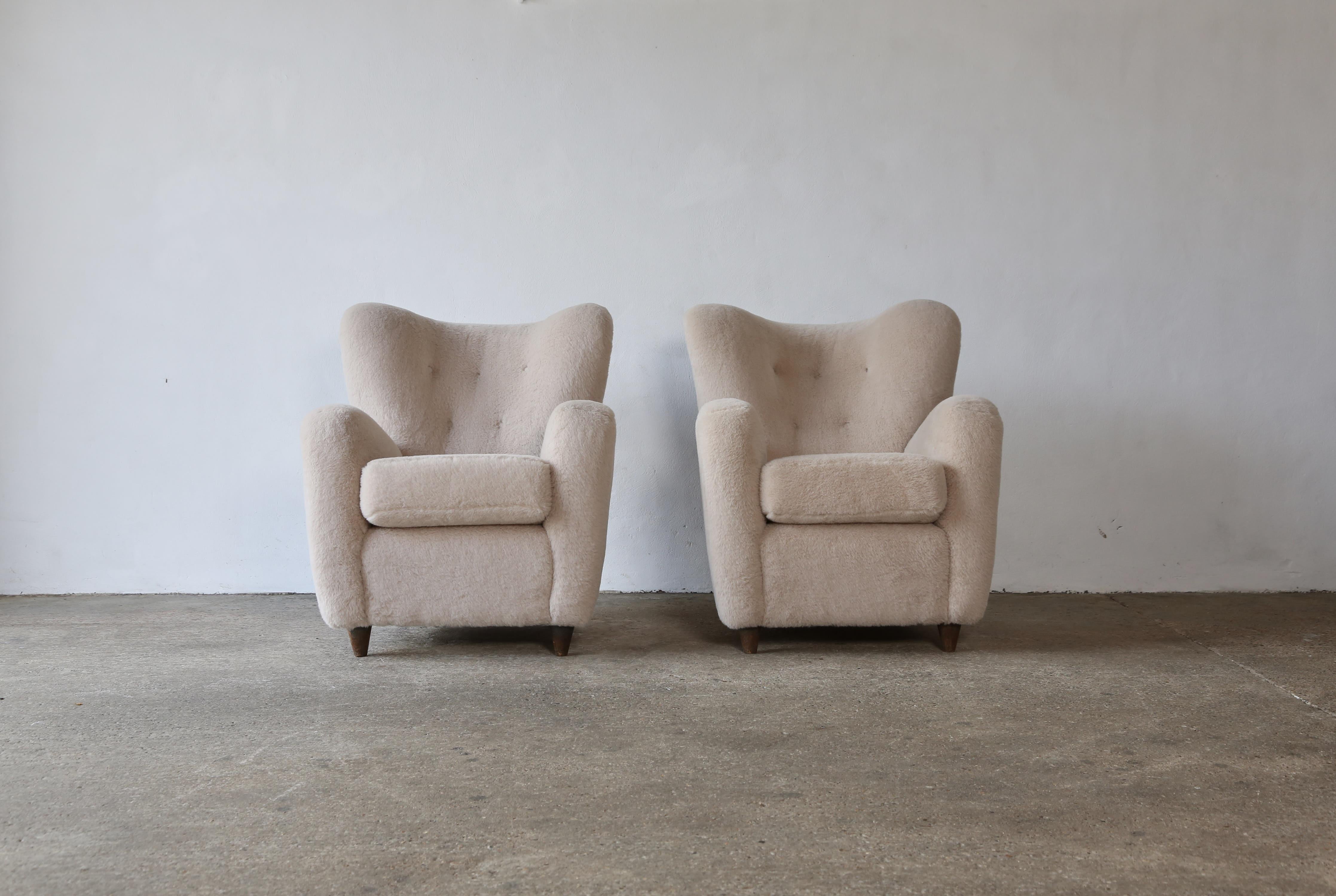 A large pair of armchairs attributed to Paolo Buffa, Italy 1950s. Newly upholstered in a premium, soft, ivory pure alpaca wool. Fast shipping worldwide.
  


