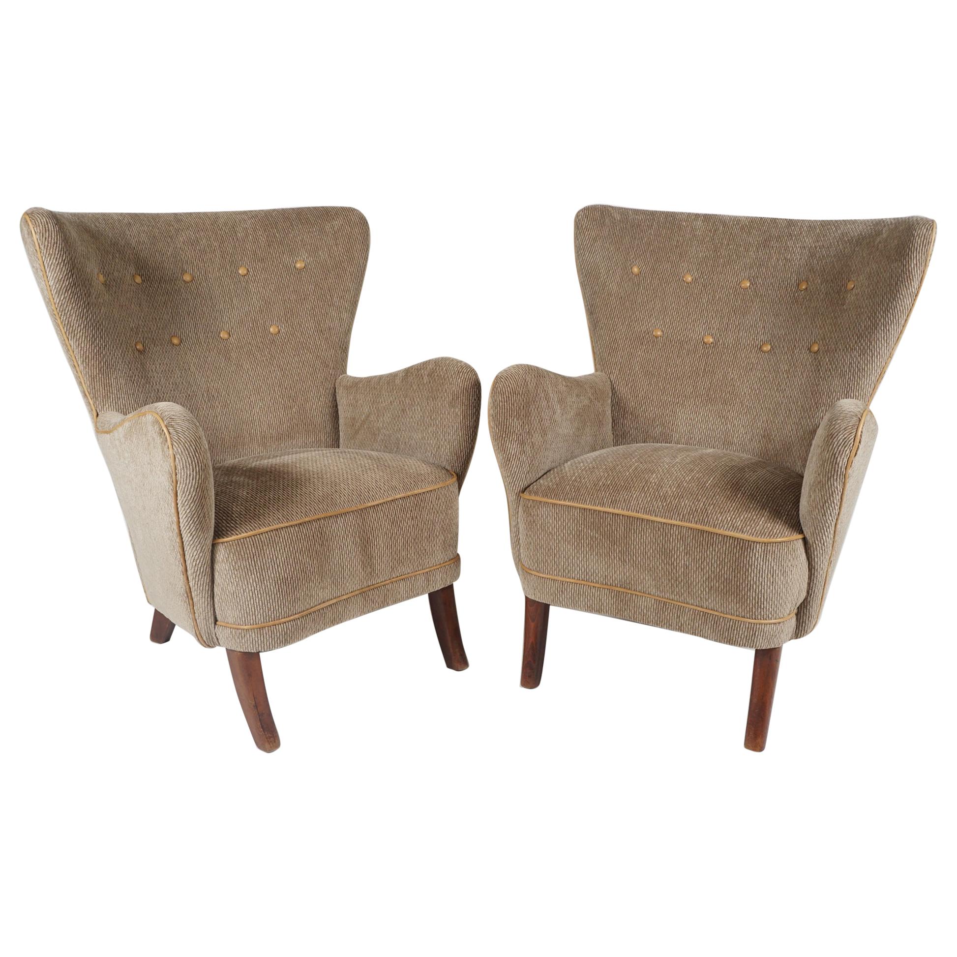 A pair of Danish modern armchairs by Danish designer Alfred Christensen. These are a contrast to
his well-known 'open arm' armchairs in that they are fully upholstered. Very comfortable, high backed
with exaggerated arms, newly upholstered in a