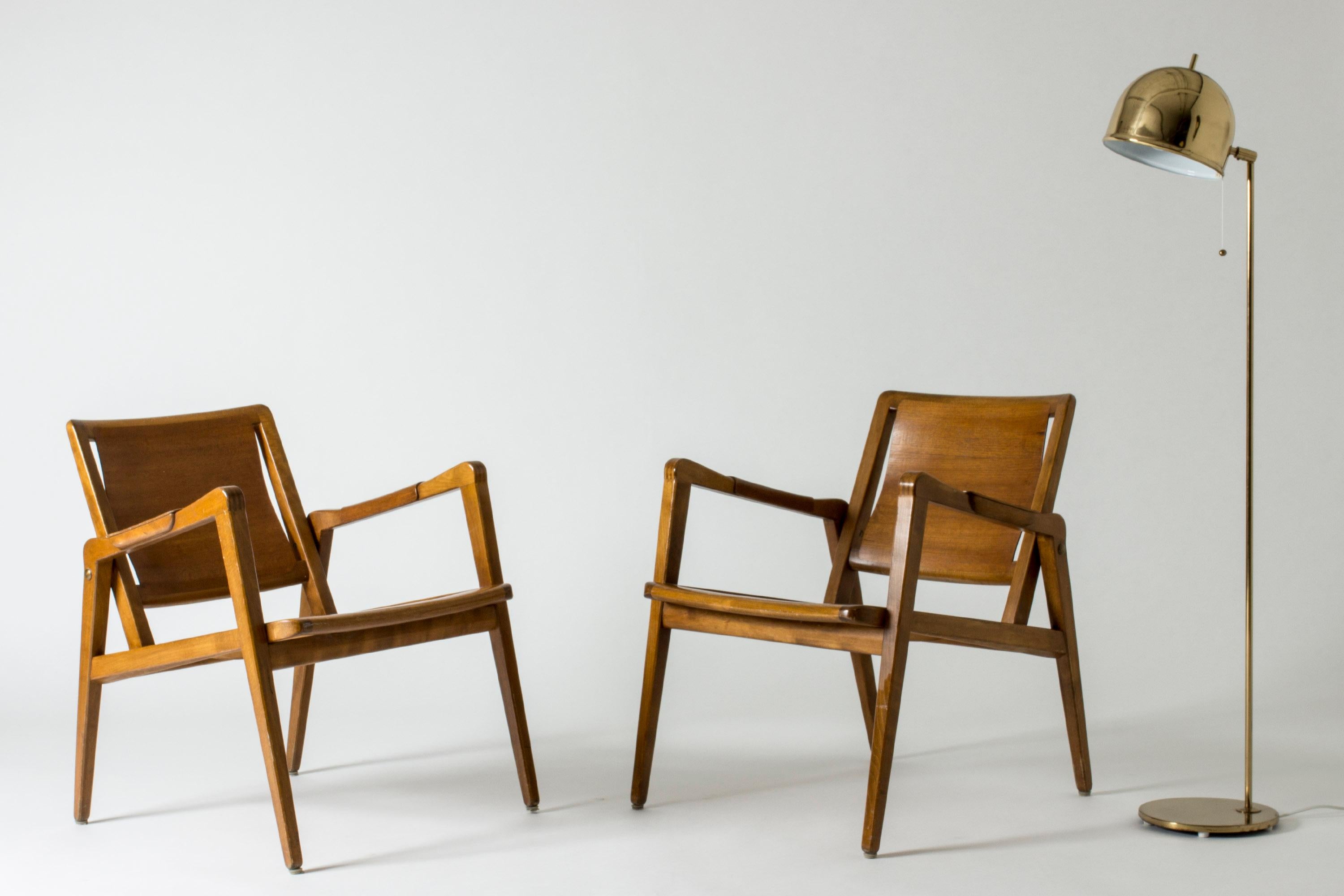 Pair of rare lounge chairs by Axel Larsson made entirely from wood in a warm color. Casually elegant design. The seats and backs follow the form of the body, neat wooden details on the armrests.

Measure: Seat height 40 cm.

  