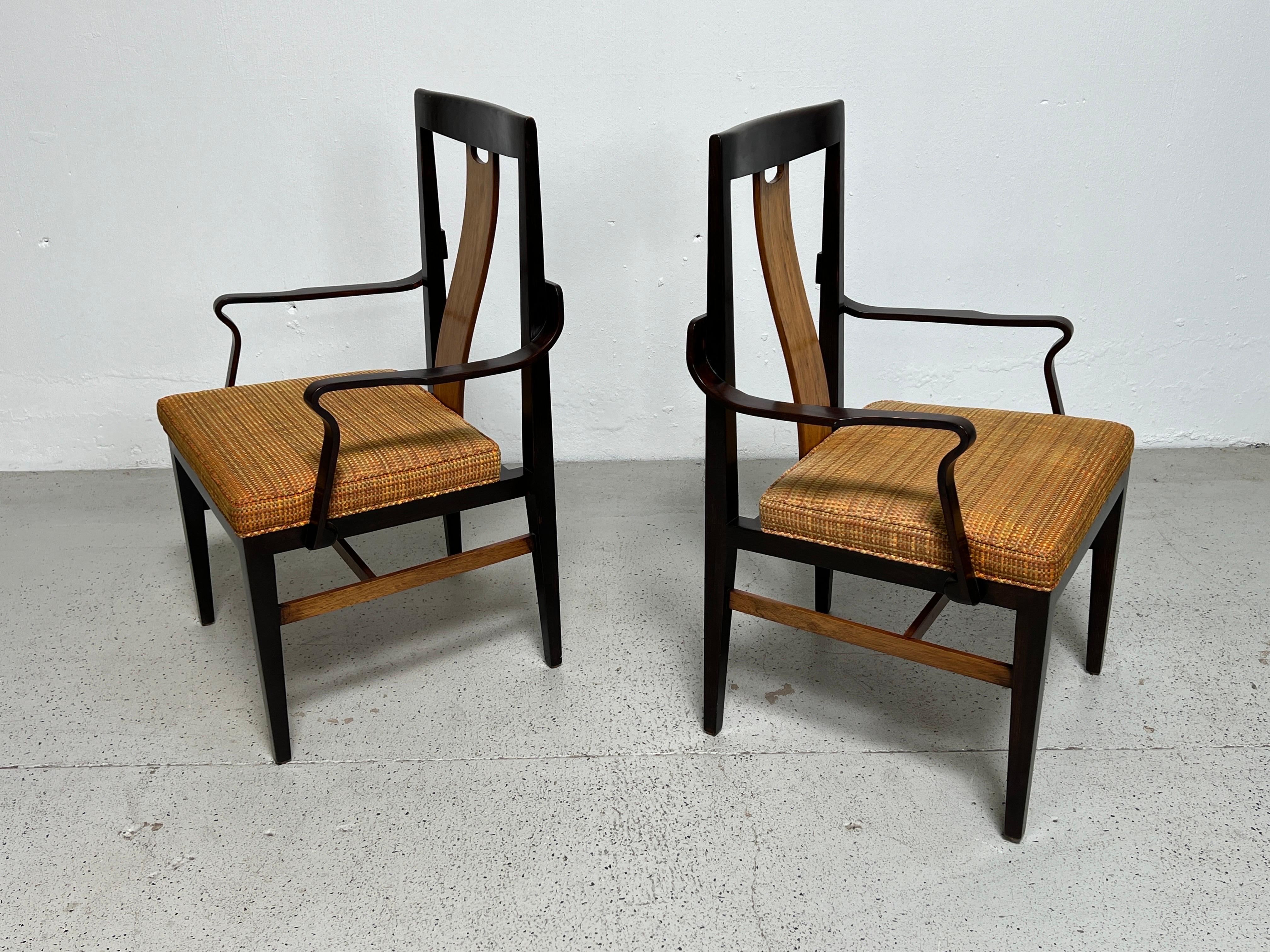 A rare pair of ash and rosewood armchairs designed by Edward Wormley for Dunbar. Matching set of four side chairs available separately. 