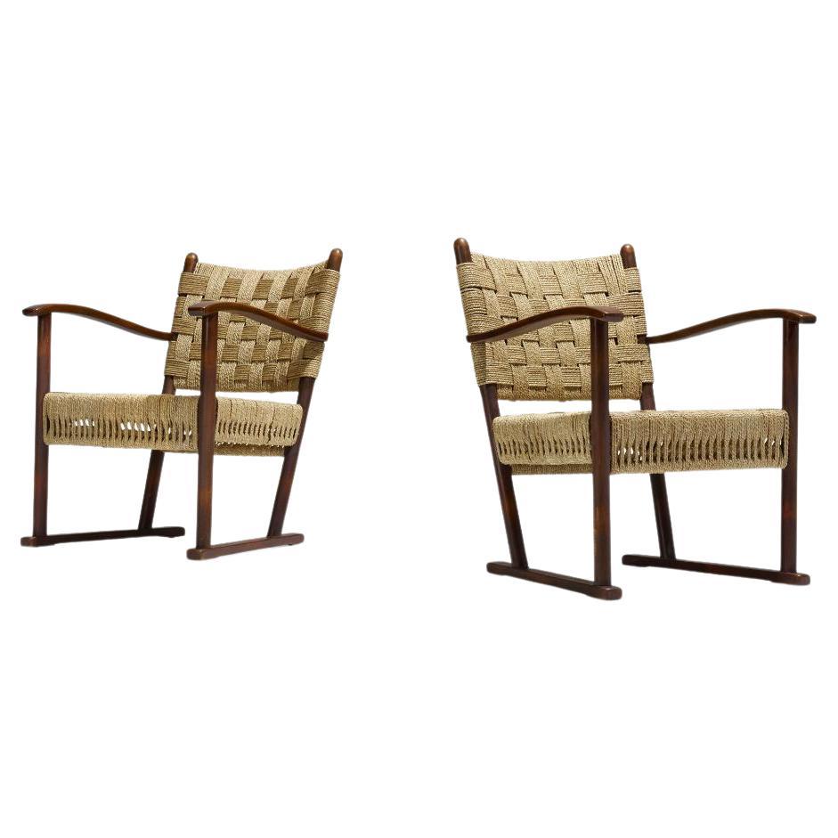 An incredible set of armchairs design by Frits Schlegel for Fritz Hansen.
The armchairs are a perfect combination of  beech and   woven jute.  
They are a beautiful example of Scandinavian Modern design.

Feel free to request a delivery rate and we