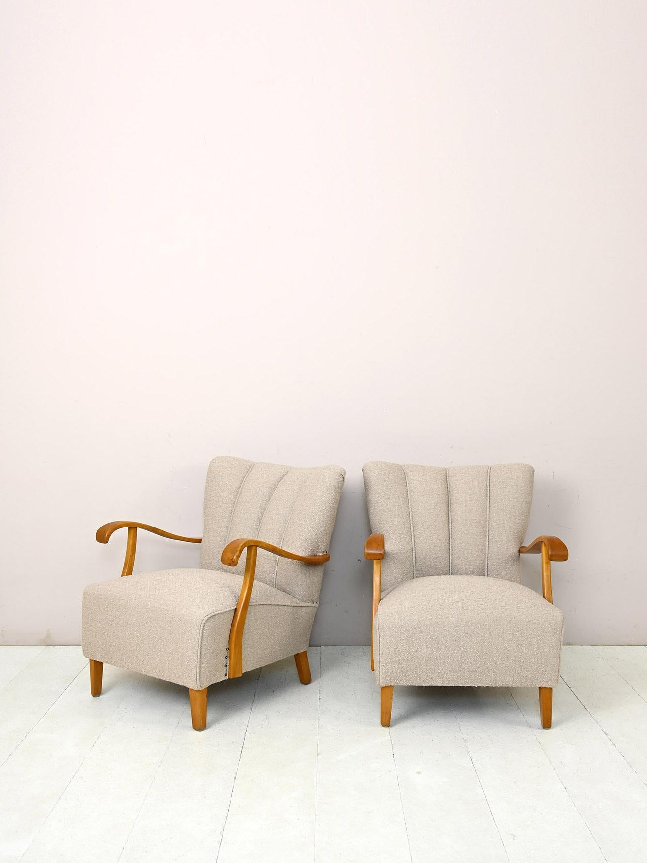 Original vintage Scandinavian armchairs.

Pair of ecru-colored bouclé fabric armchairs of Danish manufacture in the style of Fritz Hansen, produced in the 1940s.
The wide seat, refined details and soft shapes are characteristic of the style of the