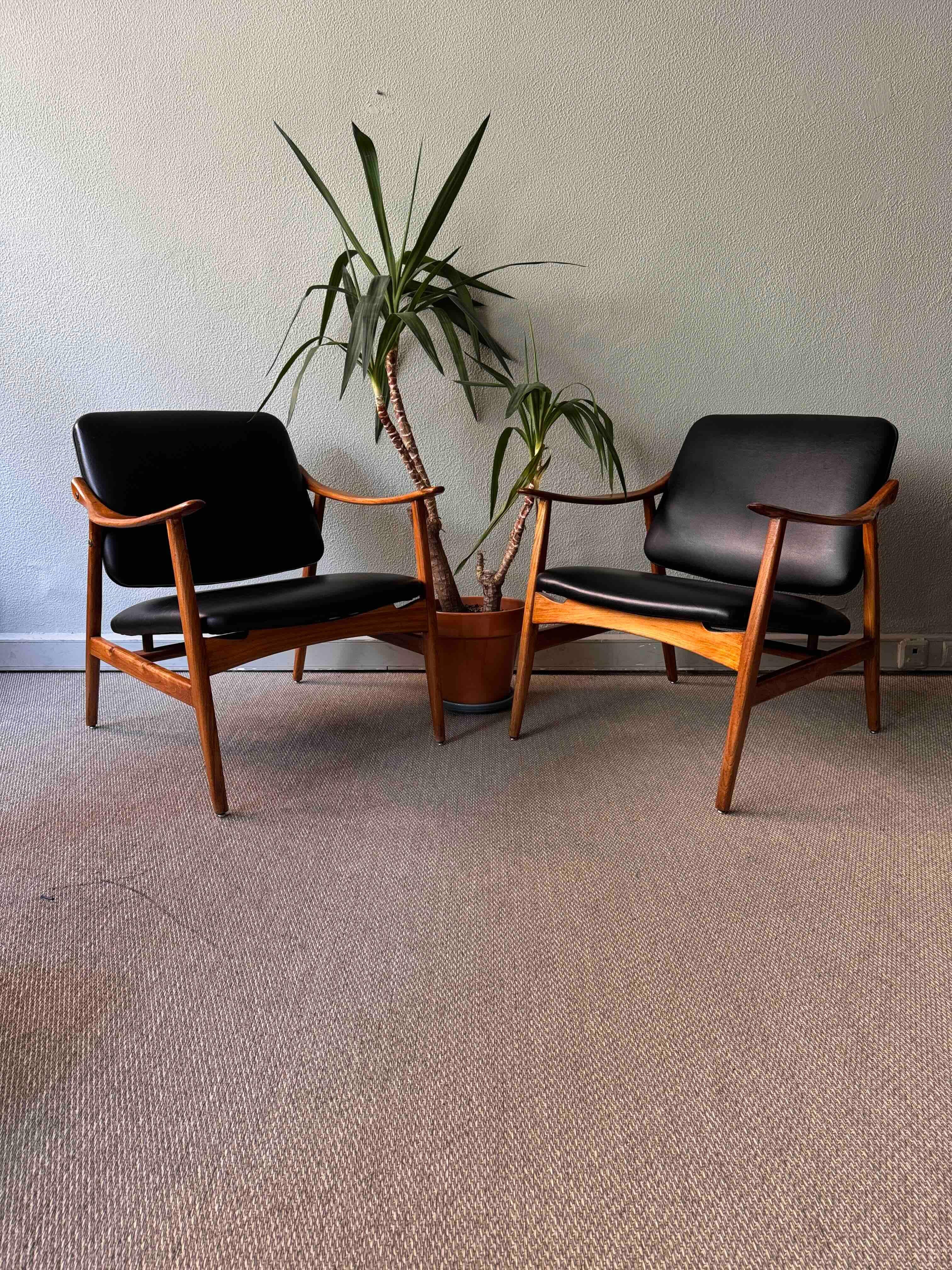 This striking pair of armchairs was designed by renowned Portuguese designer José Cruz de Carvalho for Altamira in the 1960s. A testament to the elegant minimalism of mid-century modern design, these pieces feature beautifully restored frames in