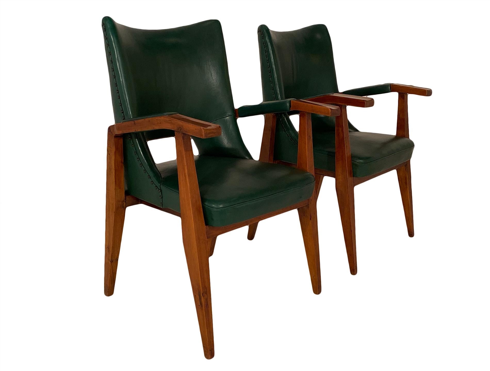 Pair of armchairs by Mario Gottardi for I.S.A. This Italian pair is made with a solid cherry wood frame and the original leather green hide in excellent condition. They are quite strong and comfortable.