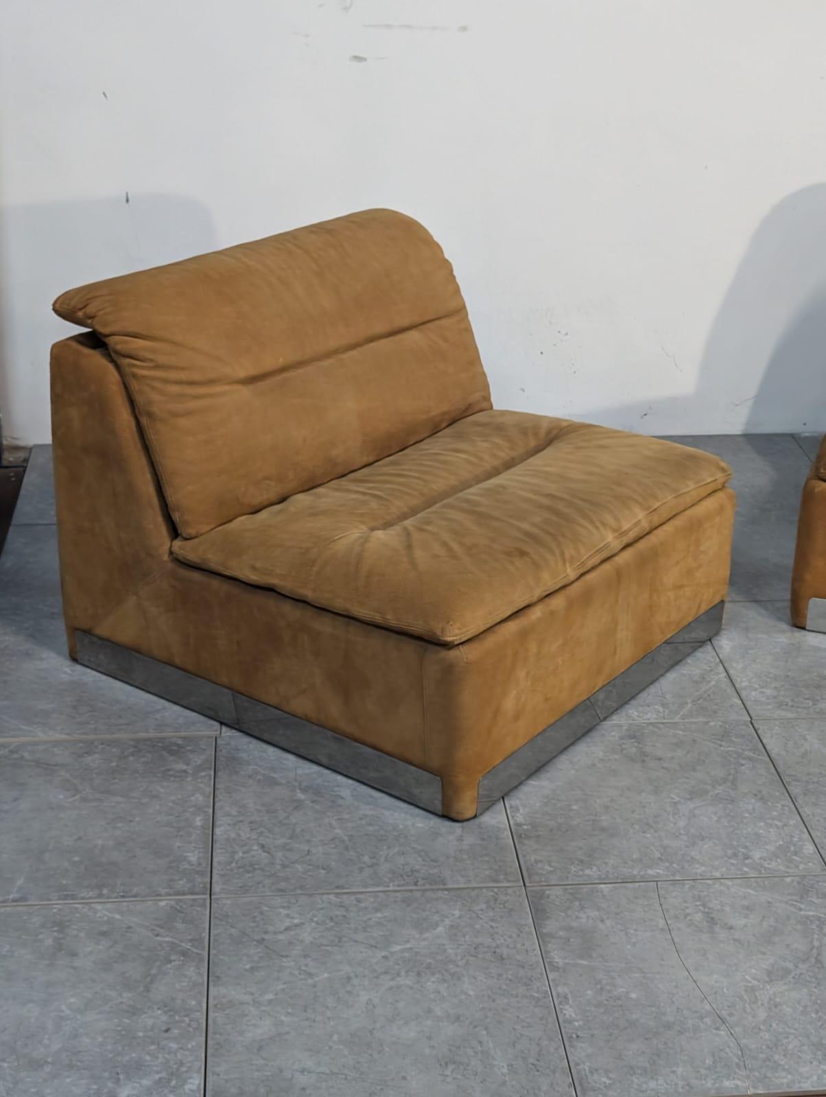Experience the fusion of steel and alcantara from the 1970s, with this exclusive pair of armchairs by Saporiti. Saporiti is an Italian furniture company, founded in 1950 by Mr. Sergio Saporiti and still under control of the Saporiti family, has