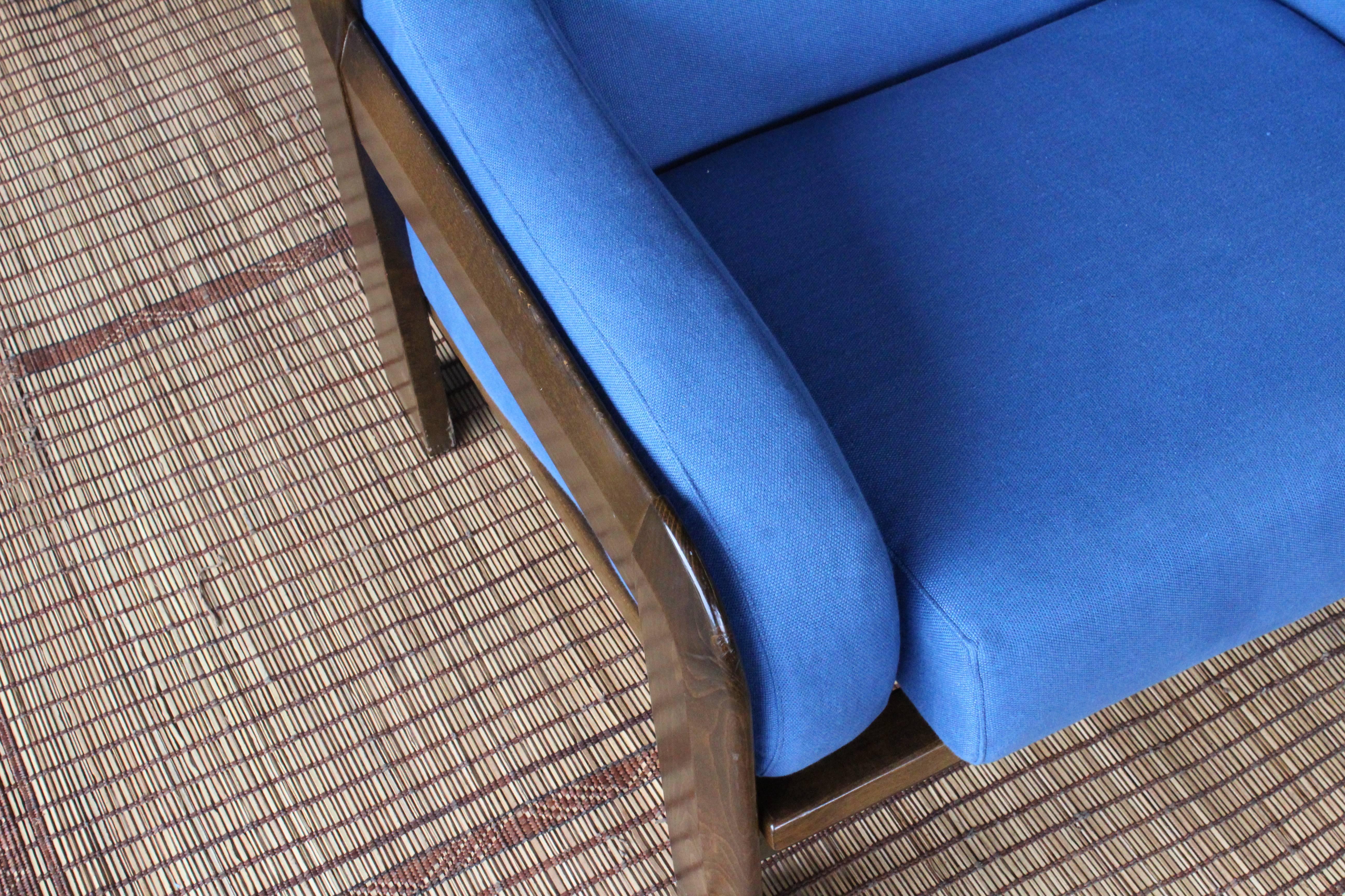 Pair of armchairs by Sillas Guilleumas crafted in solid walnut, Spain, 1970s. Loose cushions with new blue linen upholstery. The pair are in good condition with minor signs of wear.