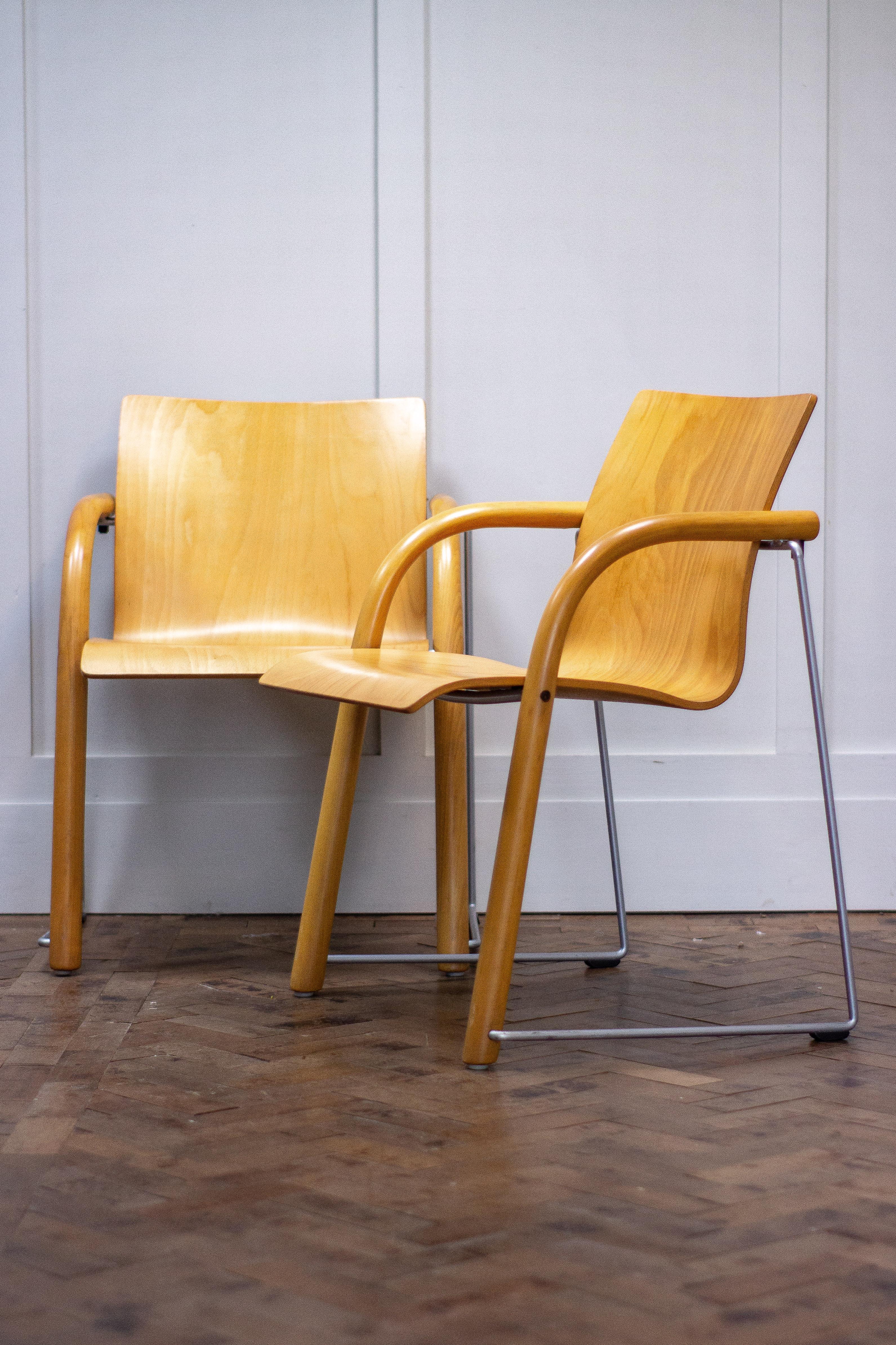 Pair of armchairs by Ulrich Bohme/ Wulf Schneider for Thonet.

These award winning chairs (S320) range were designed in 1984 for Thonet.

The chair has solid metal and beech legs, with a beech ply seat. These chairs are stackable, sturdy and