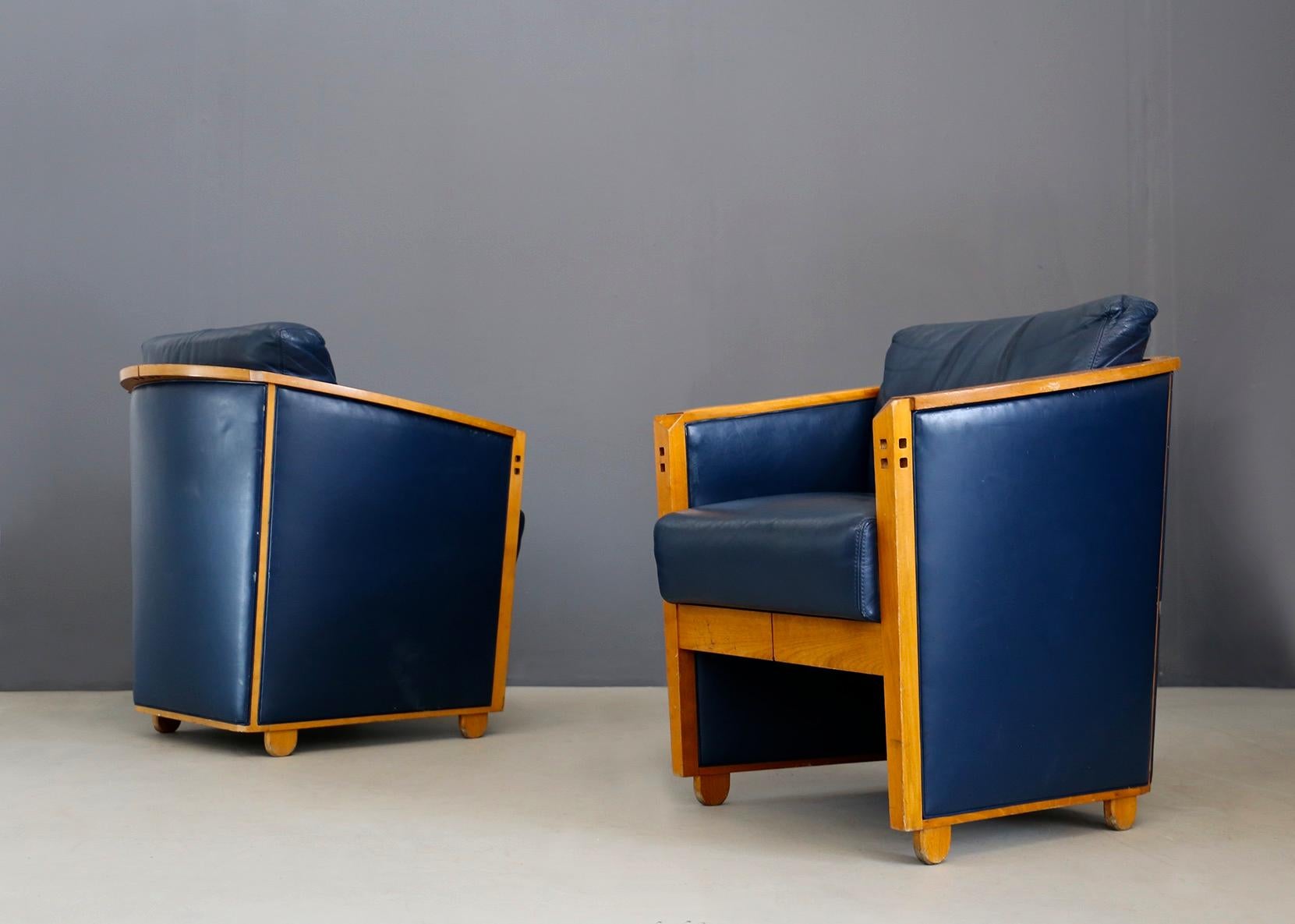 Beautiful pair of armchairs by Umberto Asnago for Giorgetti, 1990. The pair of armchairs are made of blue leather and are very well held. However, they are not damaged, but there are some imperfections due to time and wear. The armchairs have a