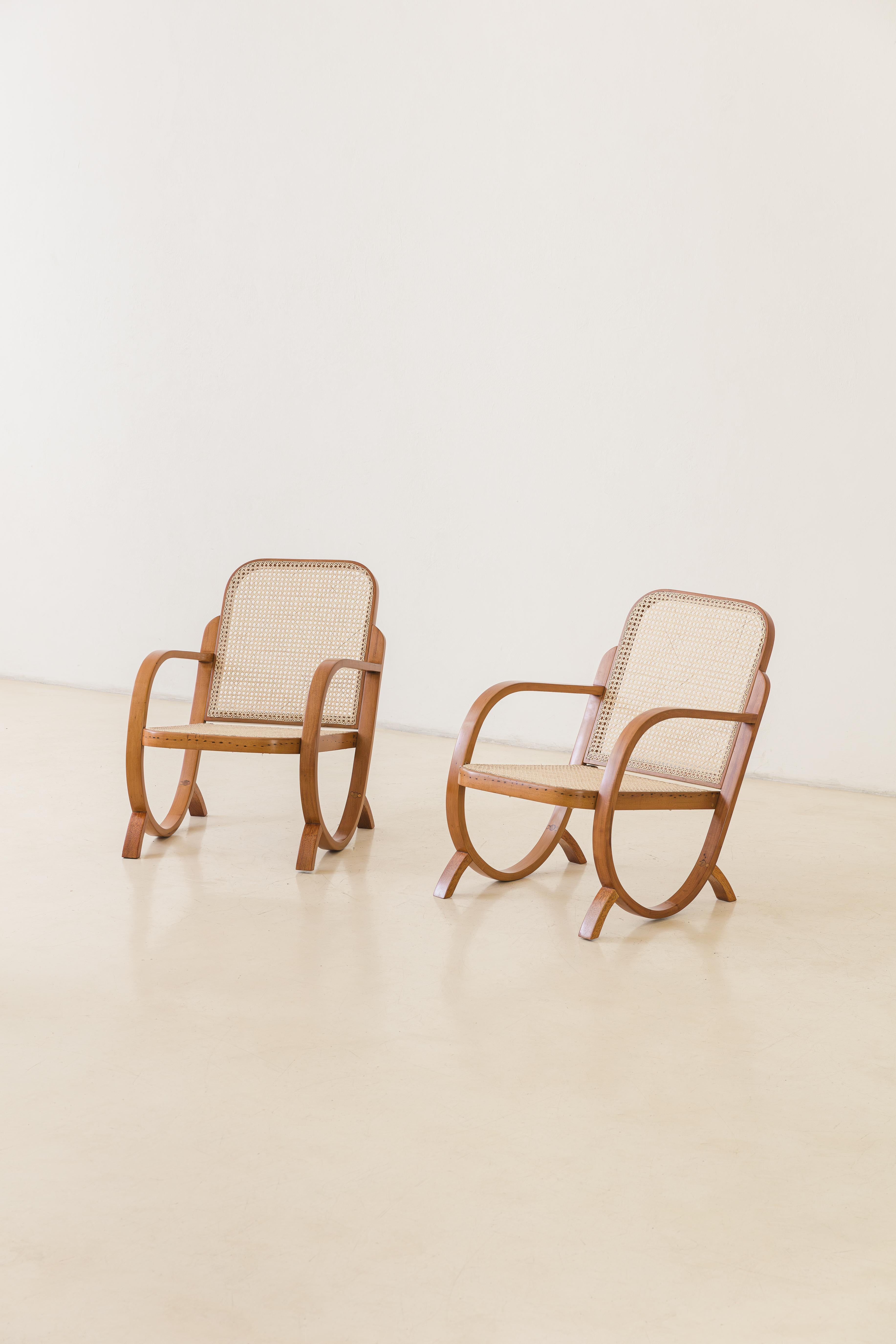 This pair of armchairs was produced by the Brazilian company Móveis Gerdau in the 1930s. The restored pieces were made of bent wood and plastic cane, which provides optimal ventilation for furniture in tropical climates. These armchairs exude