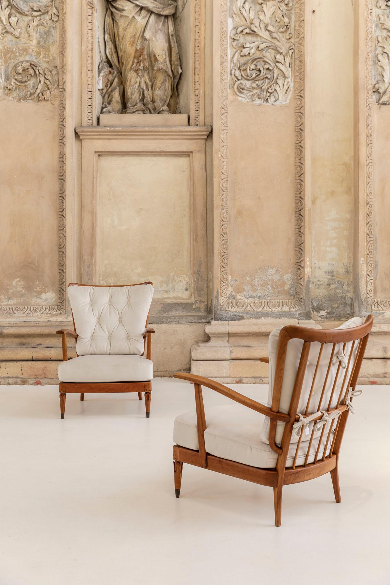 Set of two cherrywood armchairs designed by Paolo Buffa, Italy 1950 ca. 
The armchairs have a cherrywood structure, with the backrest marked by thin vertical rods, stiffened by a structural cross that continues in continuity to become an armrest.