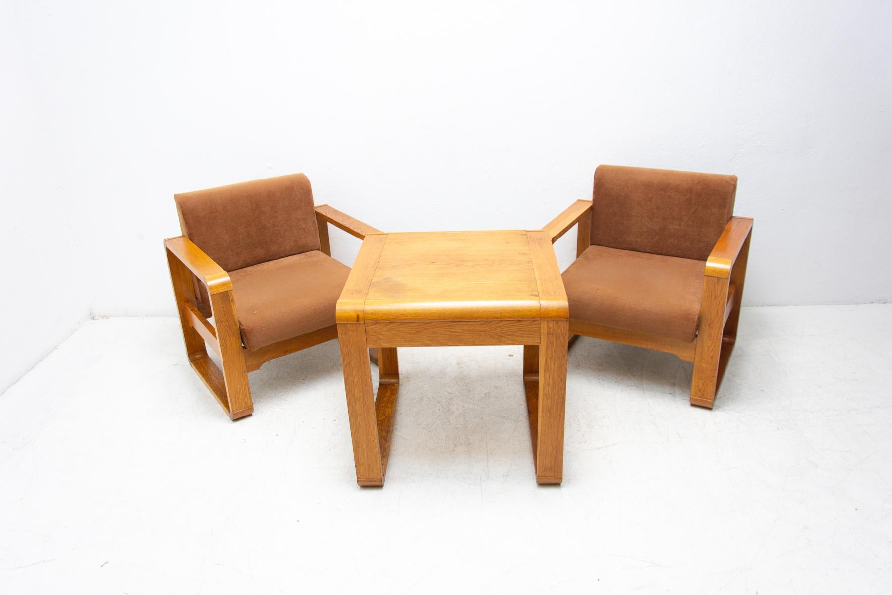 A pair of armchairs made in the 1970s for the meeting room of a Prague Hotel. The chairs are made of beech wood and have original upholstery. This is a very interesting design. The chairs are in their original preserved condition without damage,