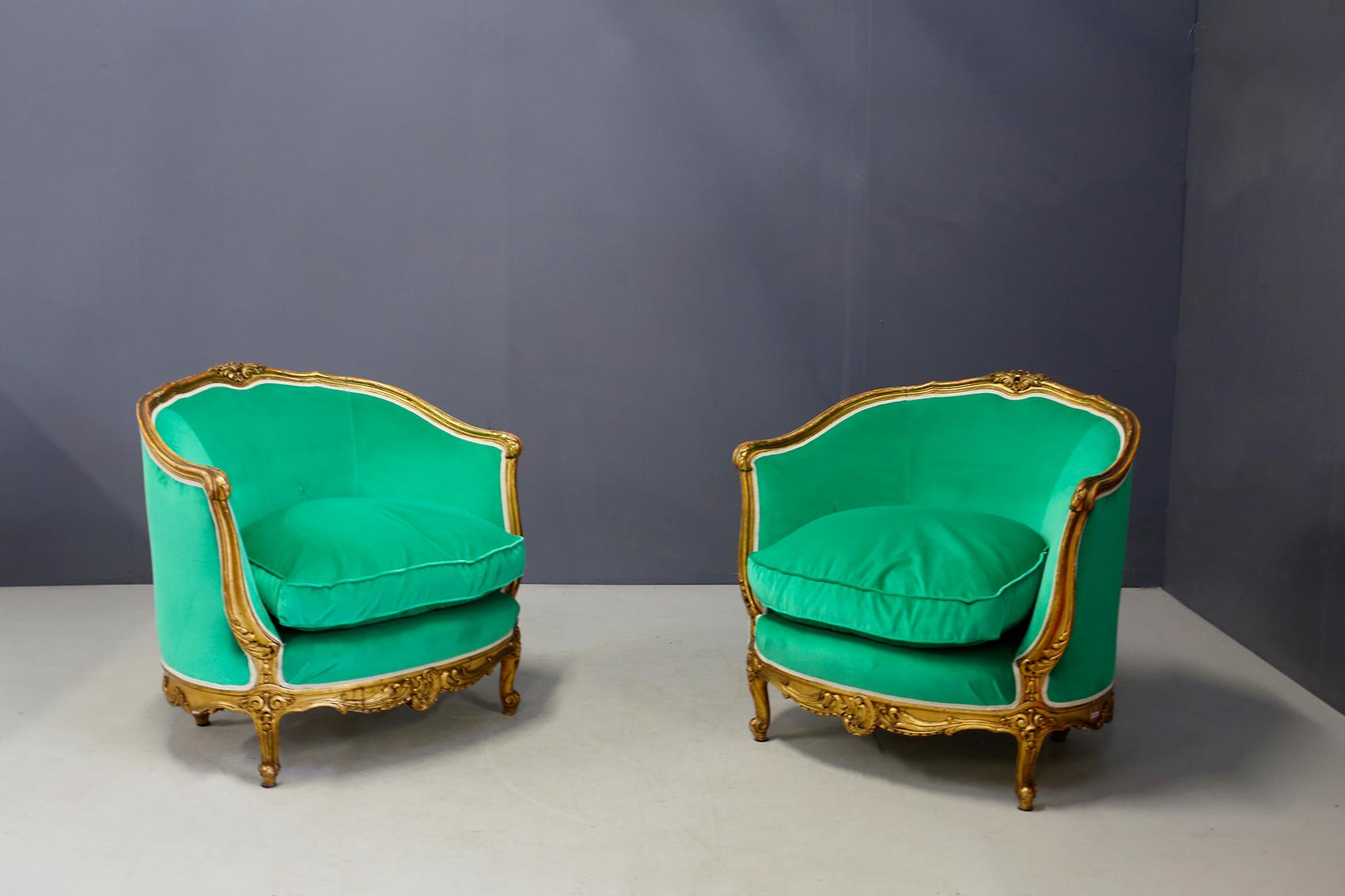 Elegant pair of armchairs of the end of the 19th century in carved gilded wood, in Louis XV style. The armchairs have been upholstered in a beautiful green velvet. 
The wood of the armchairs have been expertly inlaid and gilded. Given their age we