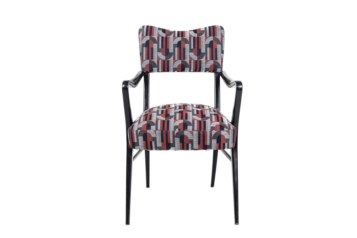 Ico Parisi, in the style of.

Pair of armchairs in black lacquered wood standing on four tapered and inclined legs linked each other with two stretchers on sides. Curved shape armrests. High back and seat covered by a fabric with geometrical