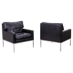 Pair of armchairs in black leather and chrome metal. 1970s.