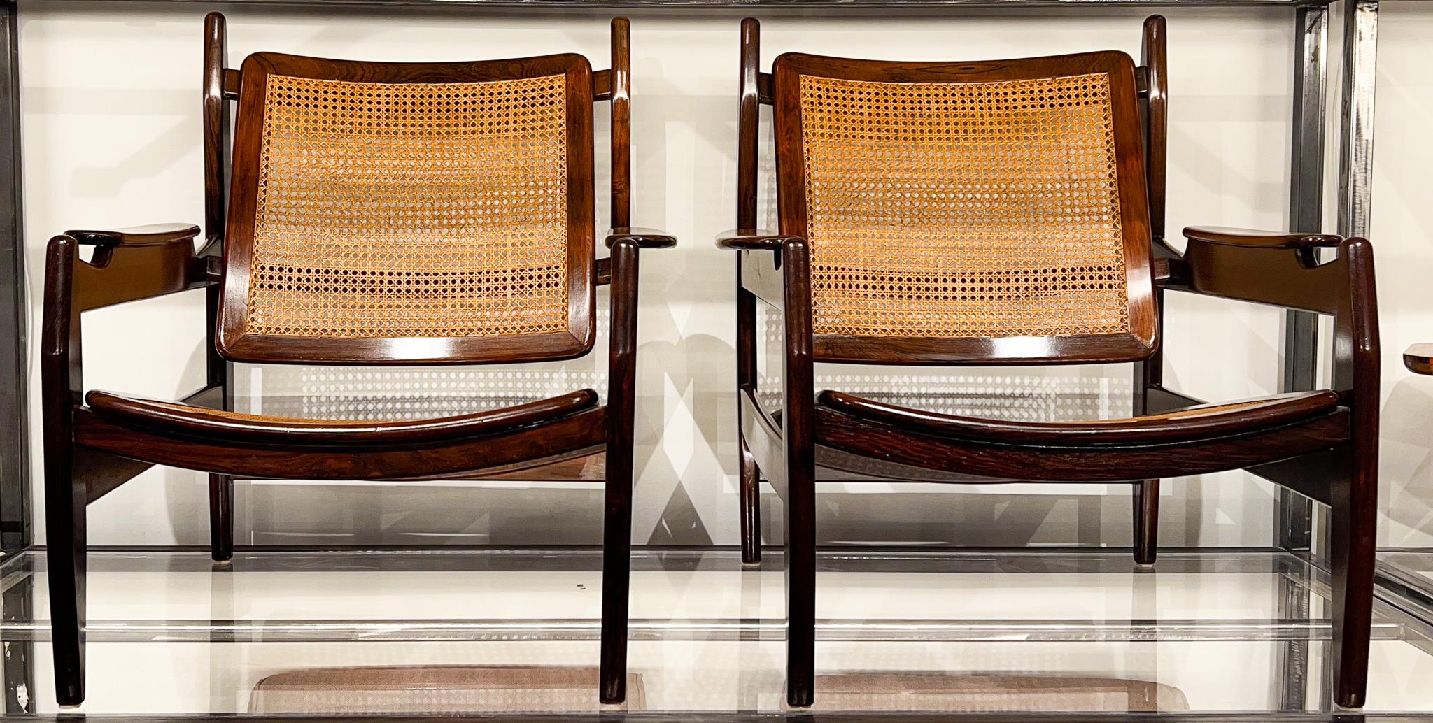 These beautifully designed armchairs by Alexander Rapoport are made in solid Brazilian rosewood (Jacaranda) and still conserve their original caning from the 1960s. Both the rosewood and cane are in excellent condition, making the chairs sturdy and