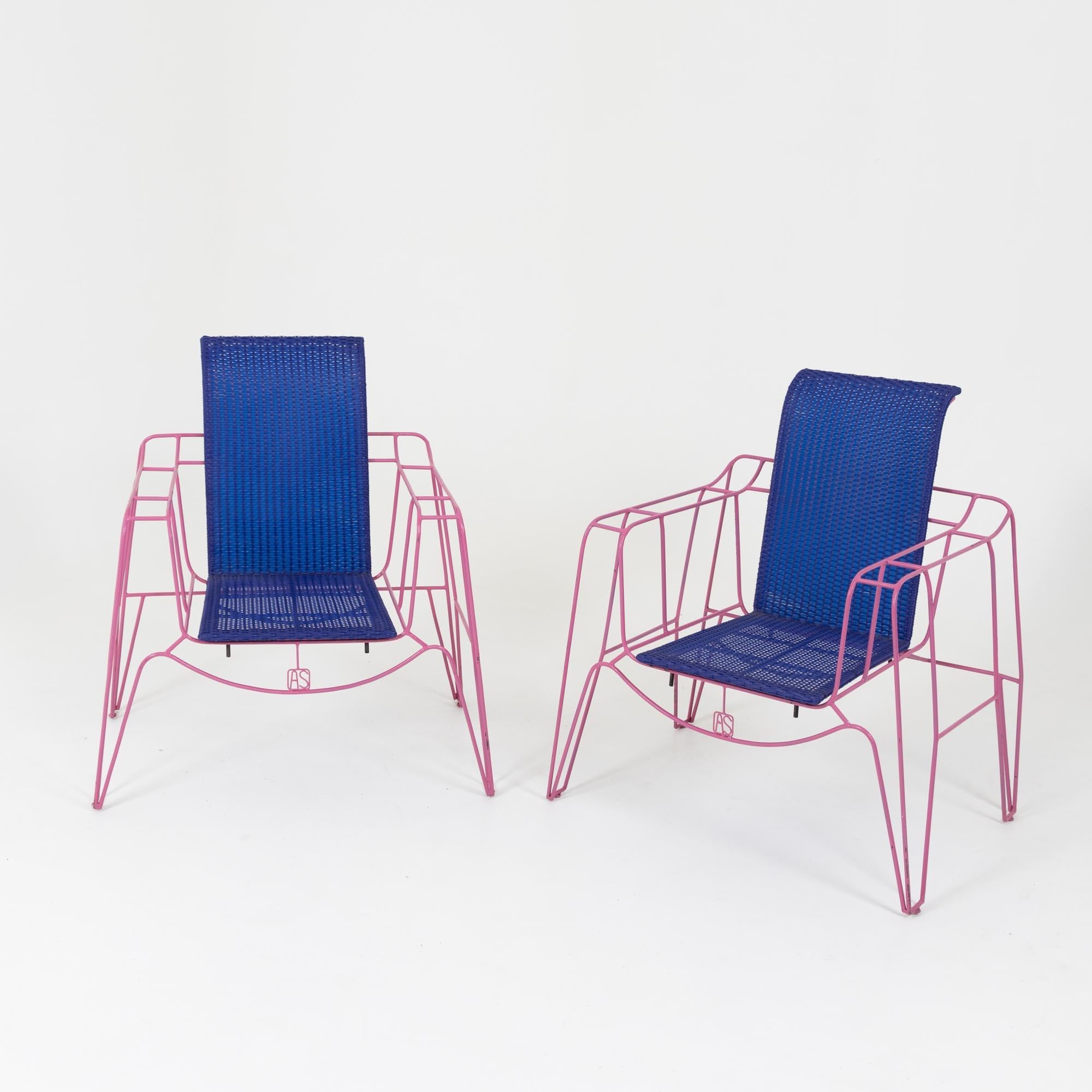 Pair of armchairs by Anacleto Spazzapan on pink painted metal frames with blue plastic rattan seats. The monogram AS is integrated on the front of the armchairs. As a designer, Anacleto Spazzapan (b. 1943) considers himself in the service of