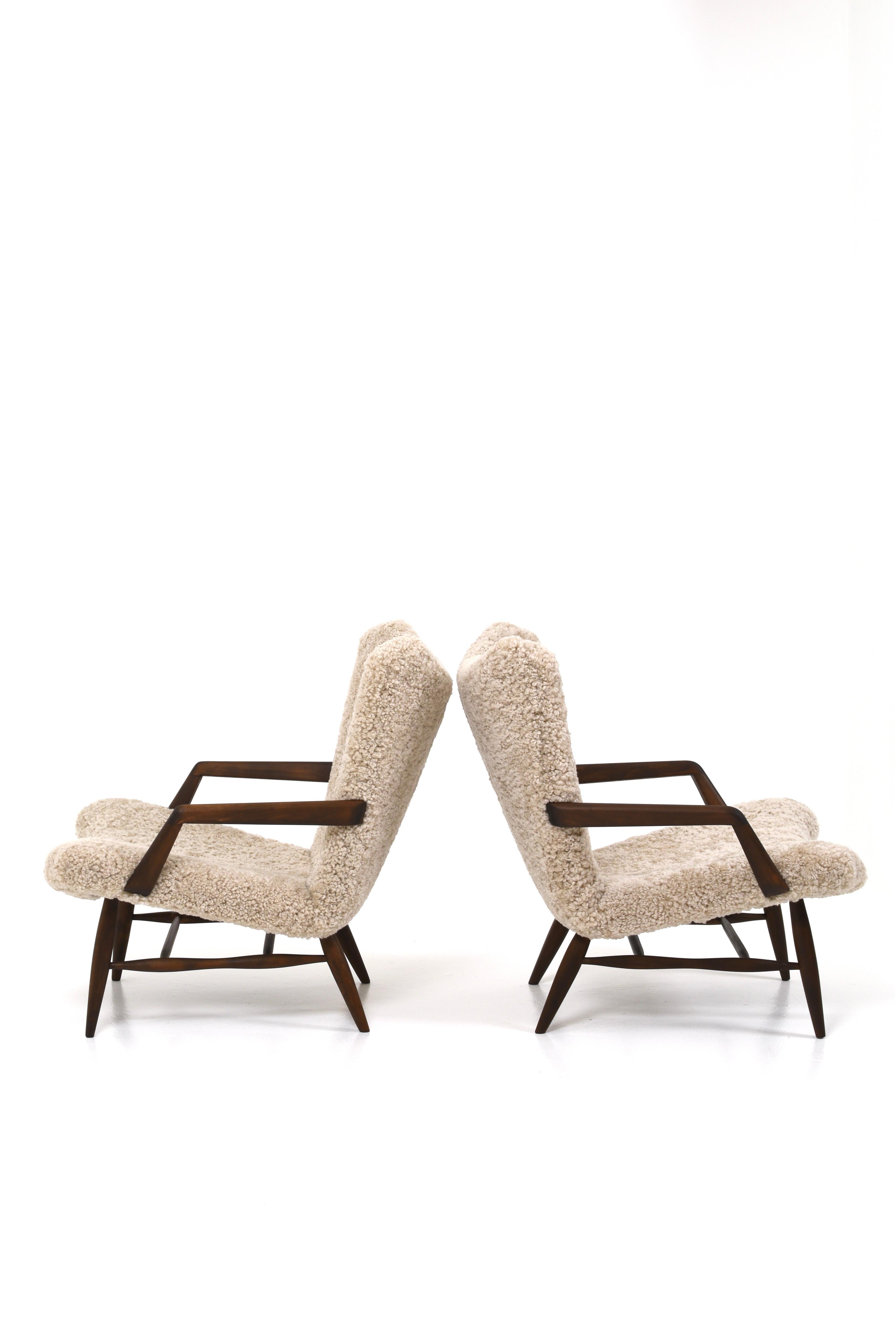 An unusual armchair model designed by Svante Skogh.
The frame of the armchair is sanded, stained and oiled. It has a matte finish. 
Both armchairs are upholstered in beige sheepskin.

The armchairs are very comfortable to sit in and very beautiful.