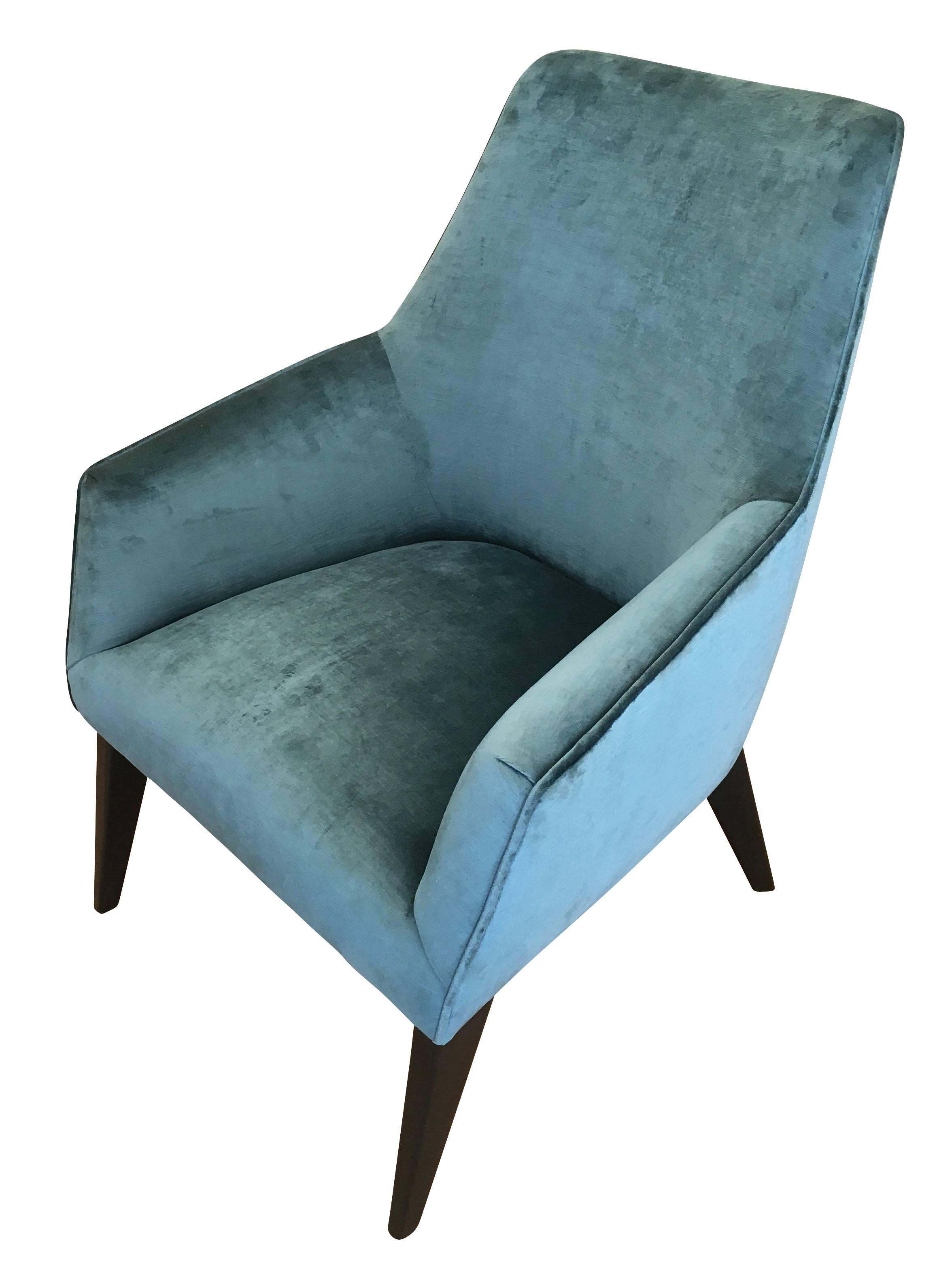 Pair of midcentury lounge chairs in the manner of Gio Ponti with ebonized legs. One has been upholstered in a teal velvet for display purposes and the other is still in original condition. Price per pair but can be sold separately if needed.