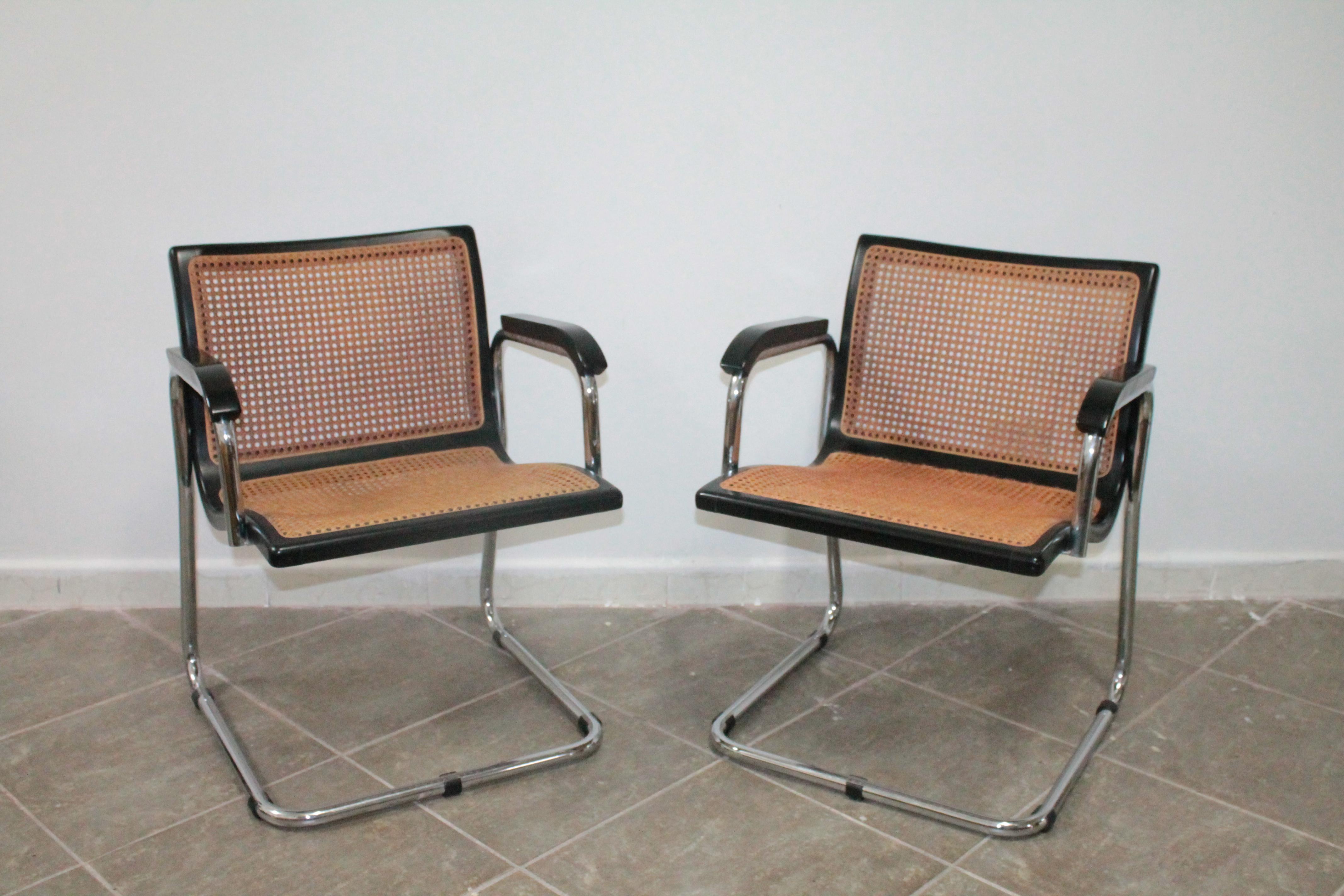 Fabulous pair of 1970s armchairs in the style of Marcel Breuer chromed tubular structure and original seat in wood and Vienna straw that has small defects.