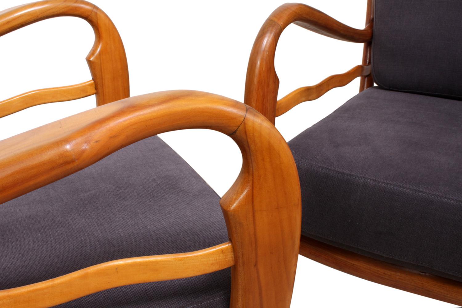 A pair of armchairs in the style of Paolo Buffa
A pair of cherrywood armchairs produced in the 1950s newly upholstered in grey blue fabric, these chairs are in very good condition.

Age: circa 1950s.

Style: Mid-Century Modern

Material: