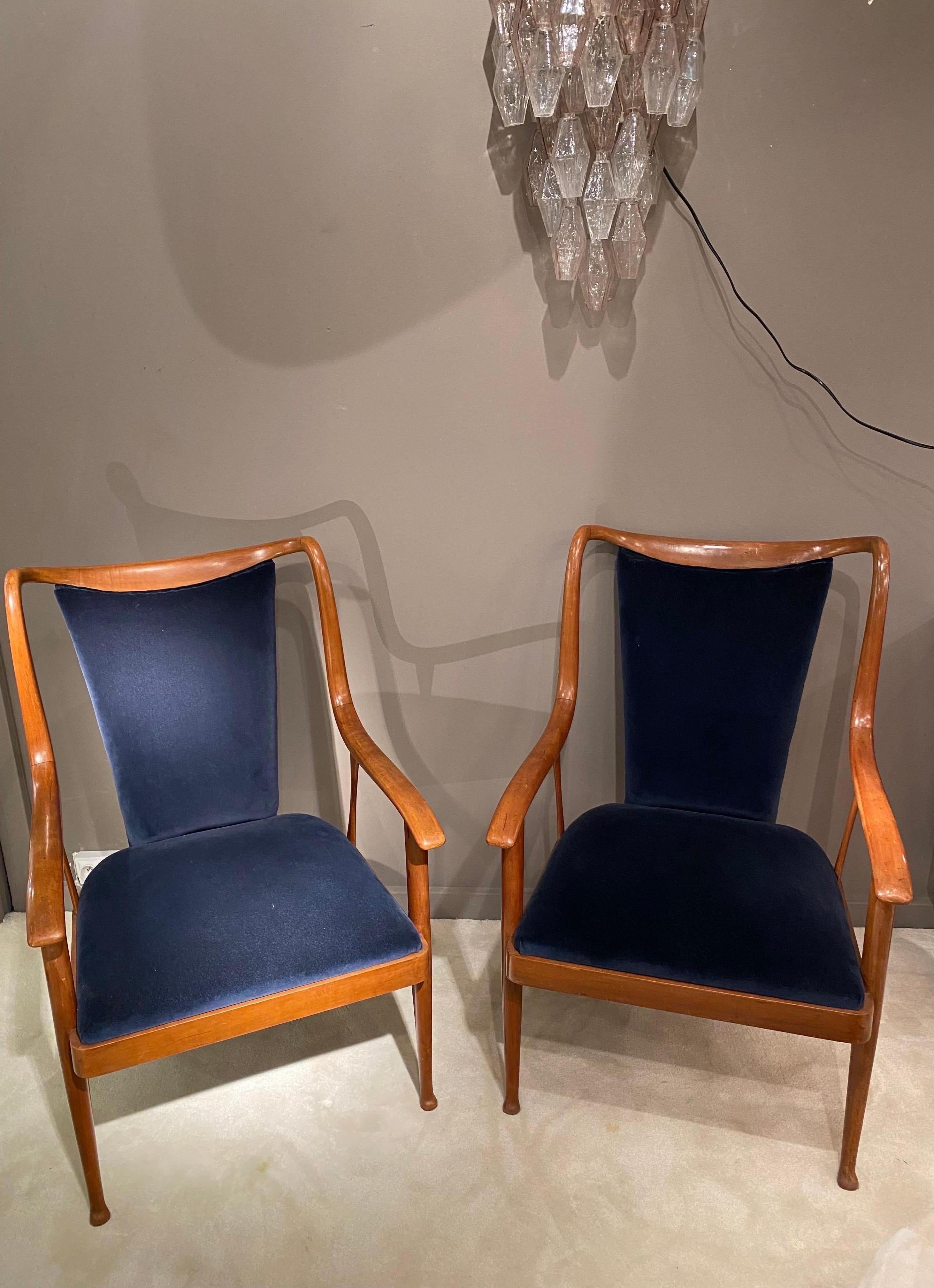 Elegant pair of armchairs by Paolo Buffa made in Italy in the 1950s. The languid and delicate structure is in walnut. Both armchairs have been reupholstered in a chic blue shimmering velvet. Look at all the details from the delicately carved base to