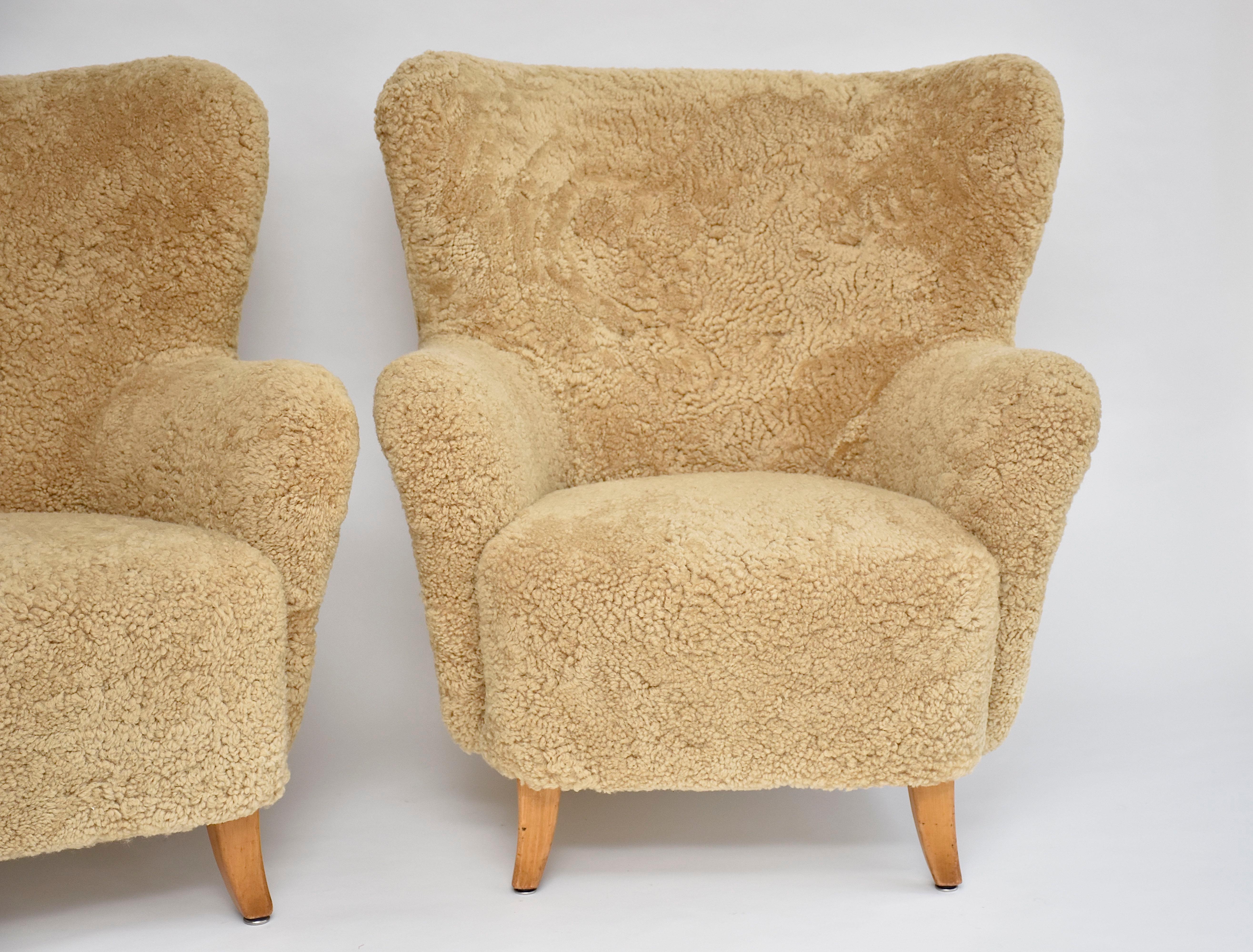 Very beautiful and unique pair of armchairs 'Laila' designed by the famous Finnish designer Ilmari Lappalainen (1918-2006) for Asko in 1948- high quality furniture company.
This iconic pair is newly upholstered in soft honey quality sheepskin and