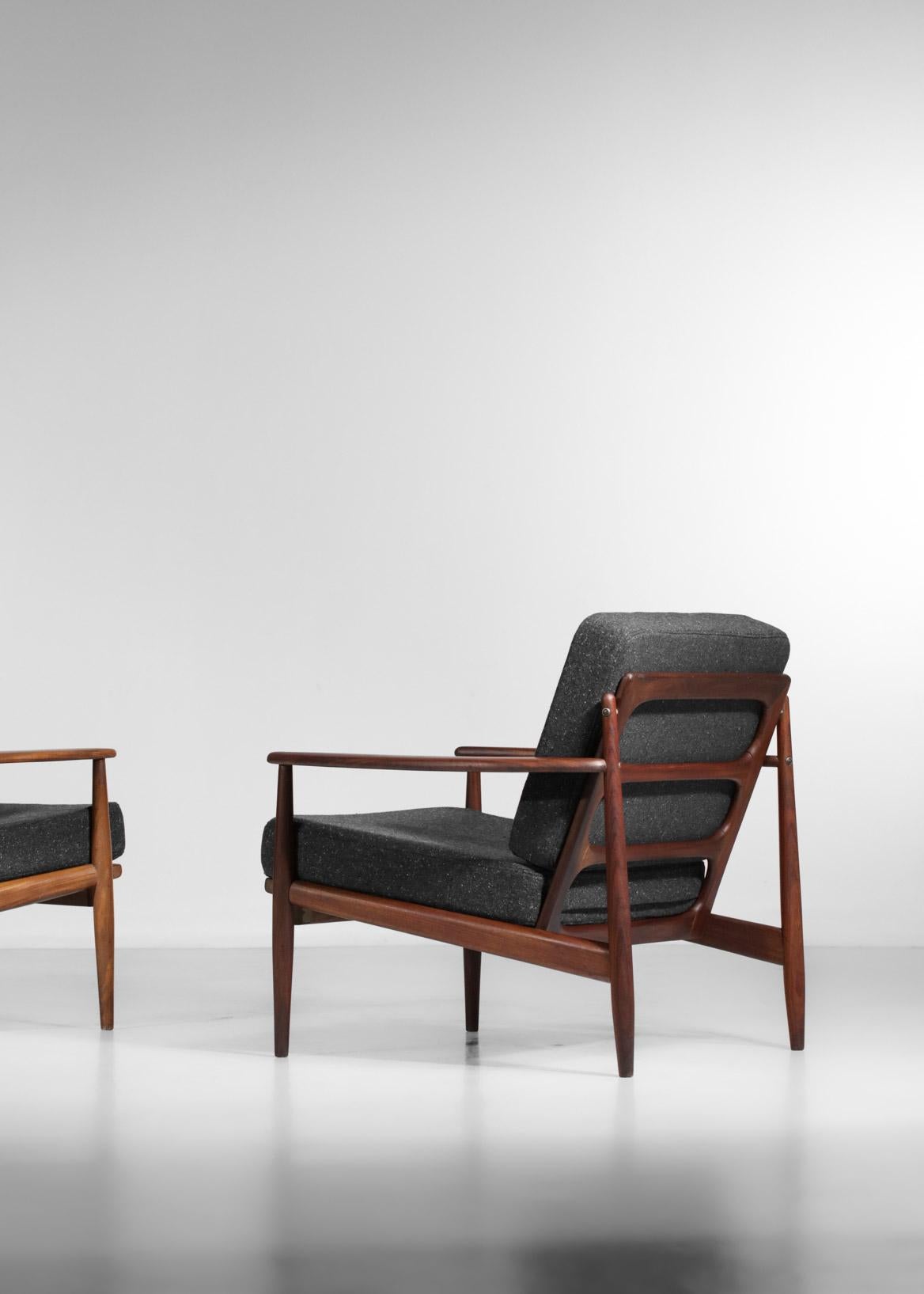 Pair of Danish armchairs from the 60's typical of the Scandinavian design of the time. Solid teak structure, seats refurbished in black wool from Bisson Bruneel. Excellent vintage condition (see pictures). Different teak species for the two