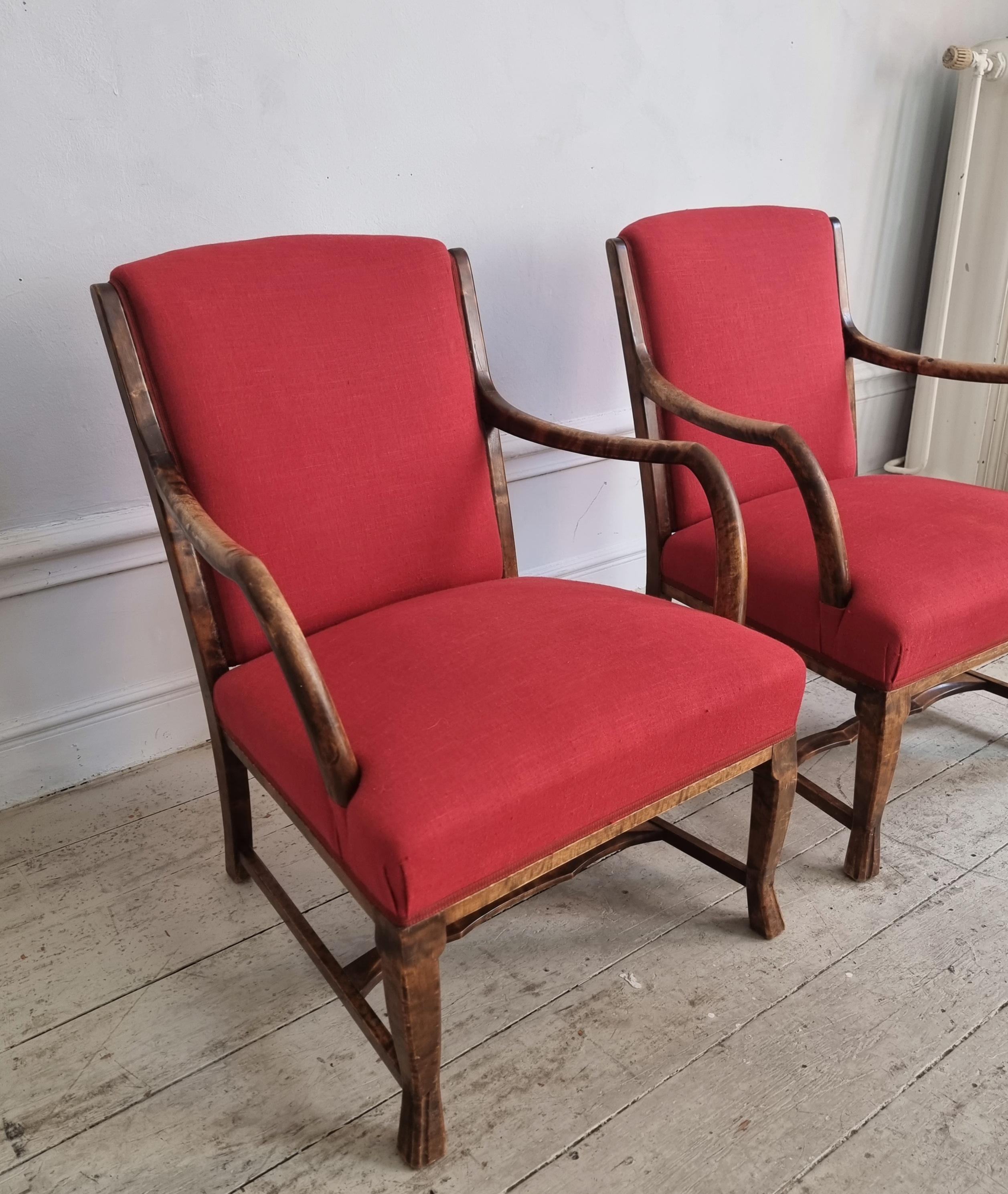 A pair of rare Swedish Grace armchairs in stained beech and red linen/cotton fabric. 

Paw shaped legs and rounded armrests. Sweden, 1930s.

In good condition, smaller signs of wear.

