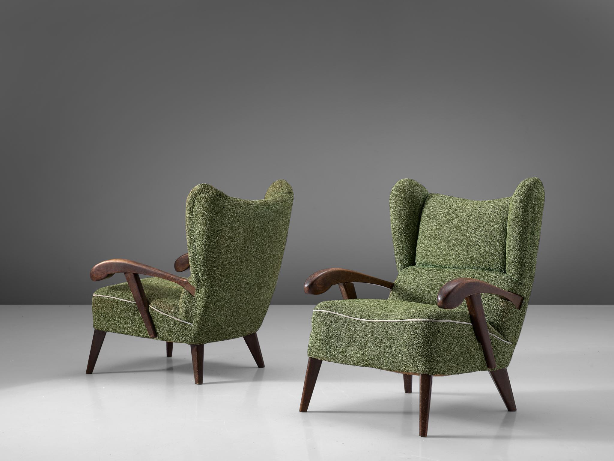 Set of two lounge chairs, in beech and fabric, Czech Republic, 1950s.

Elegant pair of two wingback chairs with solid beech frame. These armchairs show beautiful lines and curves. The grain of the stained wood is nicely visible, especially on the