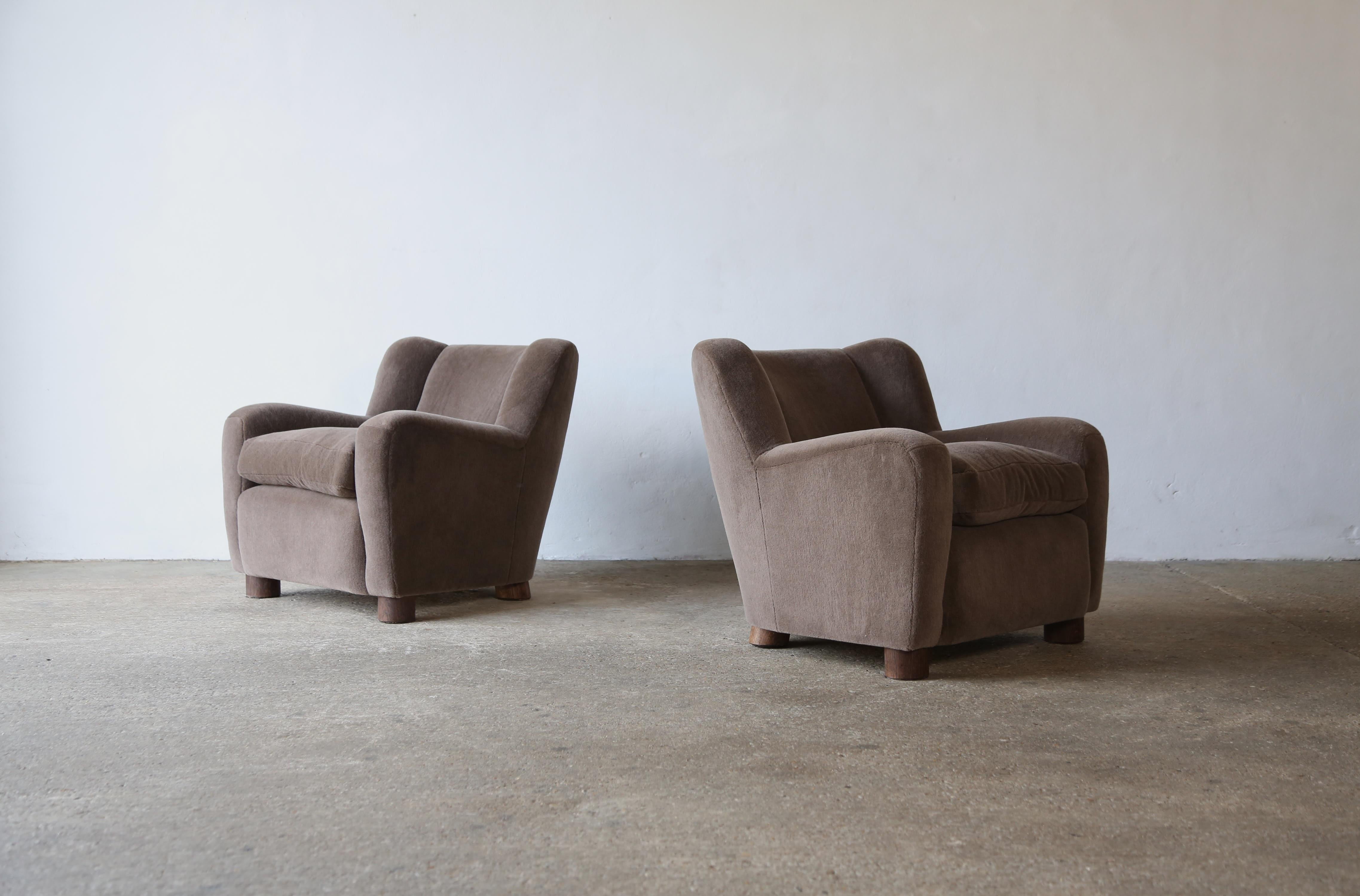 A super pair of modern armchairs newly upholstered in a premium, taupe, pure Alpaca wool fabric.   Quality handmade beech frames, traditional sprung seat, feather / fibre loose seat cushions and solid oak feet.    Handmade in England.   Available in