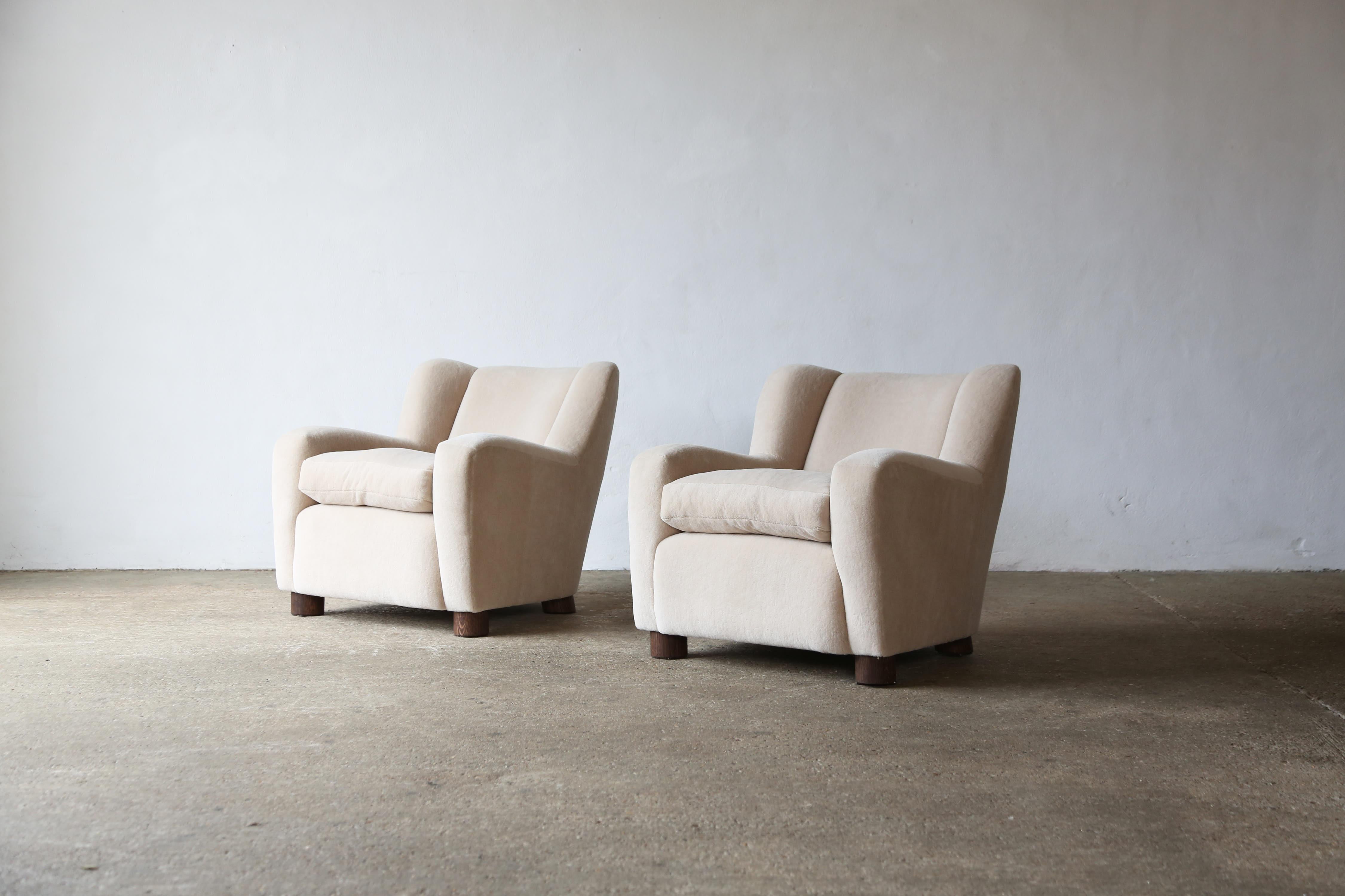 A super pair of modern armchairs newly upholstered in a premium, ivory, pure Alpaca wool fabric.   Quality handmade beech frames, traditional sprung seat, feather / fibre loose seat cushions and solid oak feet.    Handmade in England.   Available in