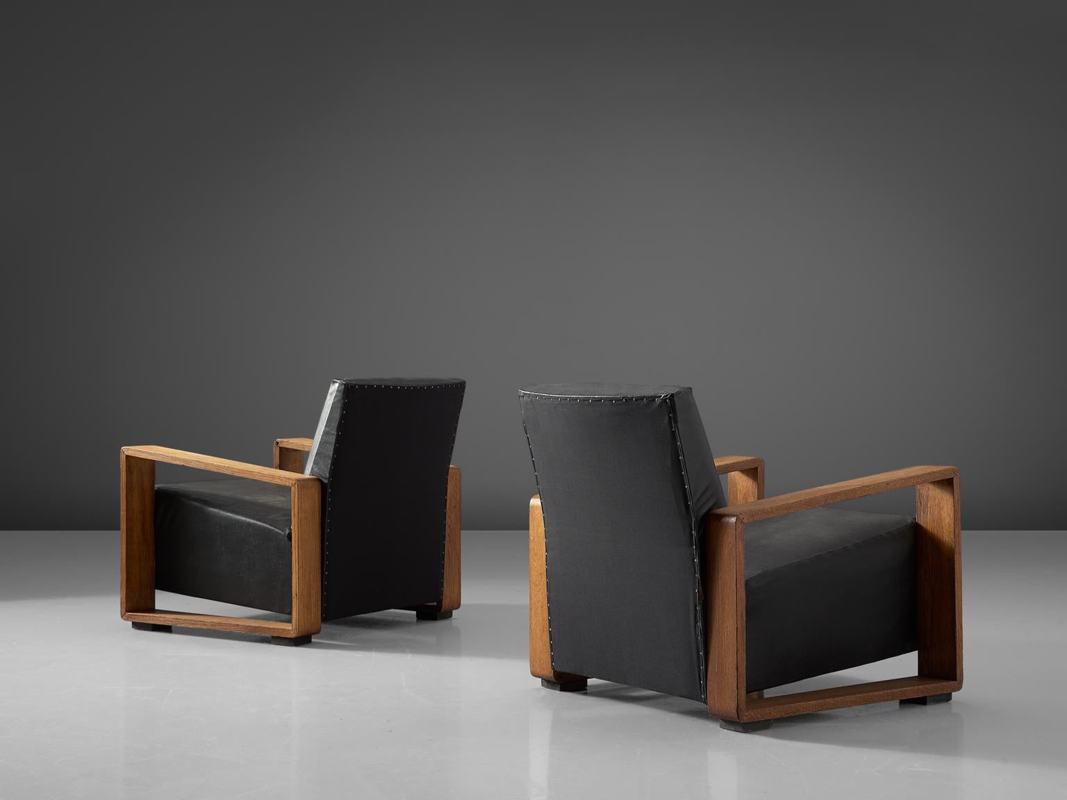 Set of two lounge chairs, in stained beech and black leather, Czech Republic, 1950s. 

In the style of Art Deco pair of two arm chairs with solid beech frame. The grain of the stained wood is nicely visible in the geometric frames. The wooden