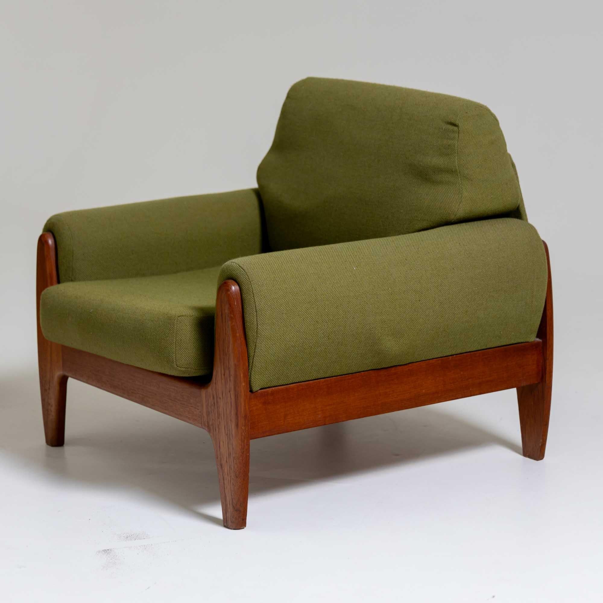 Pair of armchairs with solid teak frame and green upholstery. The armchairs are in their original unrestored condition.