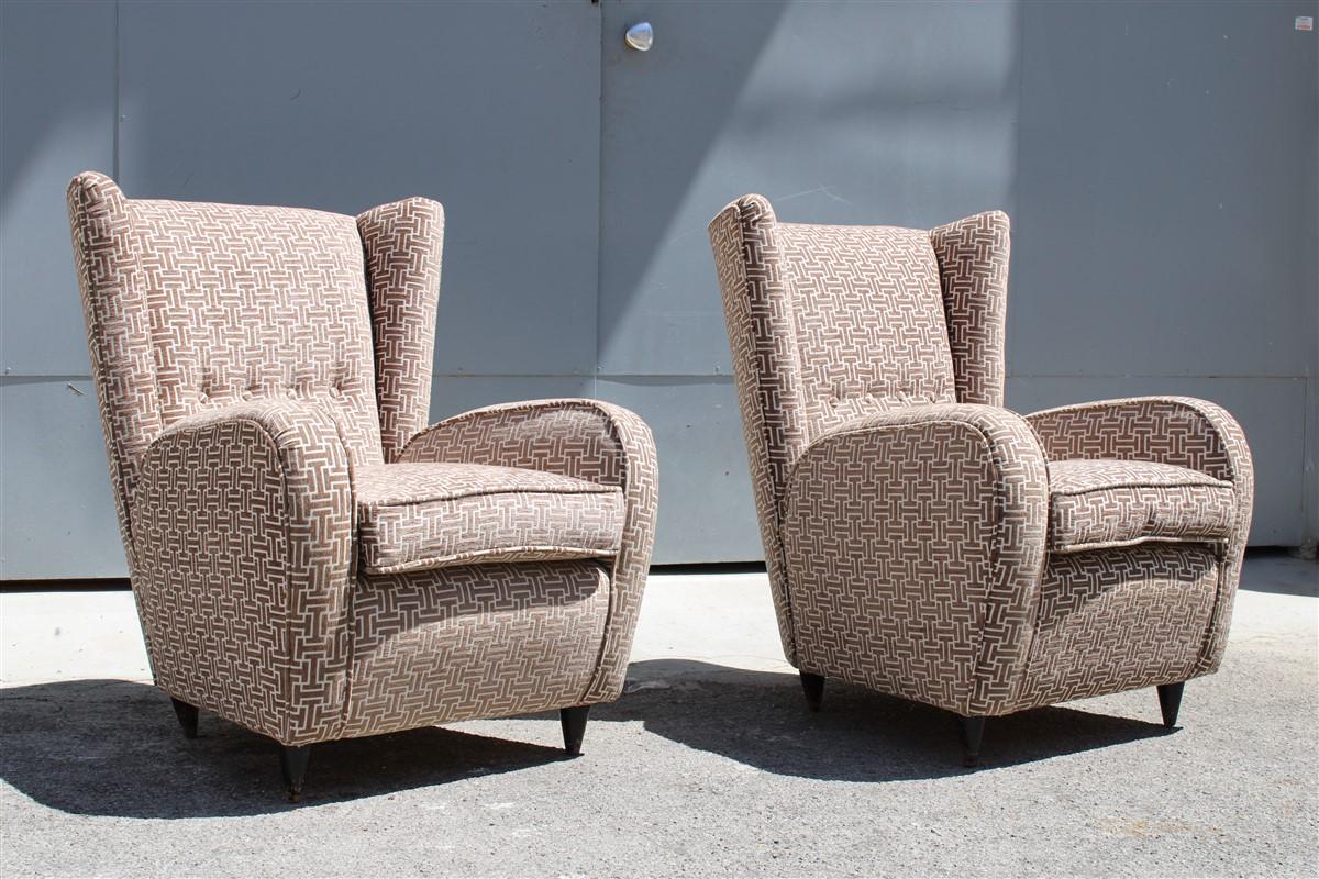 We present an amazing pair of Italian armchairs from 1950, completely restored, cone-shaped walnut feet, velvet fabric with geometric designs, inimitable Italian design.