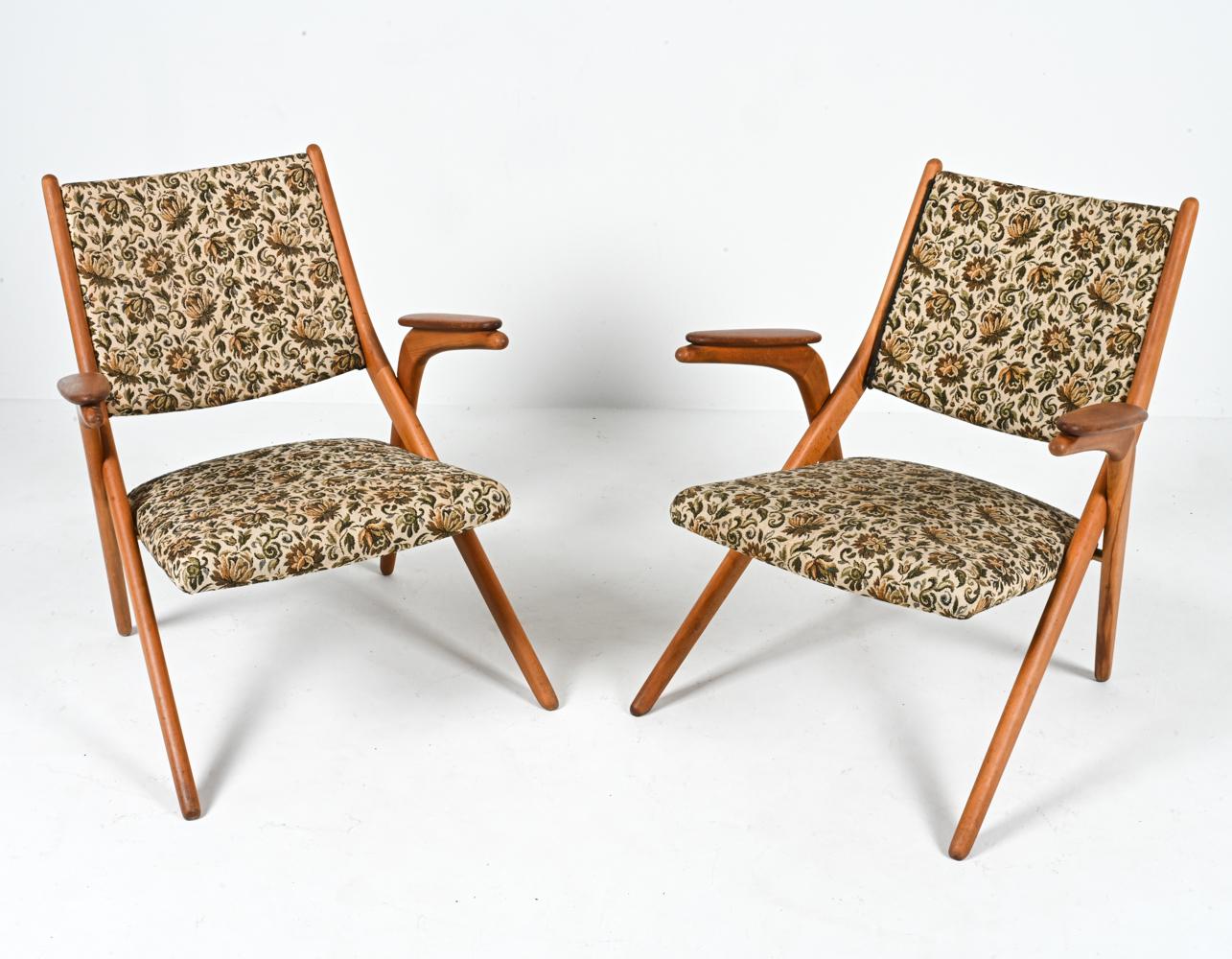 Whisk yourself away to a time where design was a reflection of nature and artistry with this enchanting pair of Swedish mid-century teak armchairs, reminiscent of the iconic style of Arne Hovmand Olsen. Radiating the golden warmth of the 1960s, each