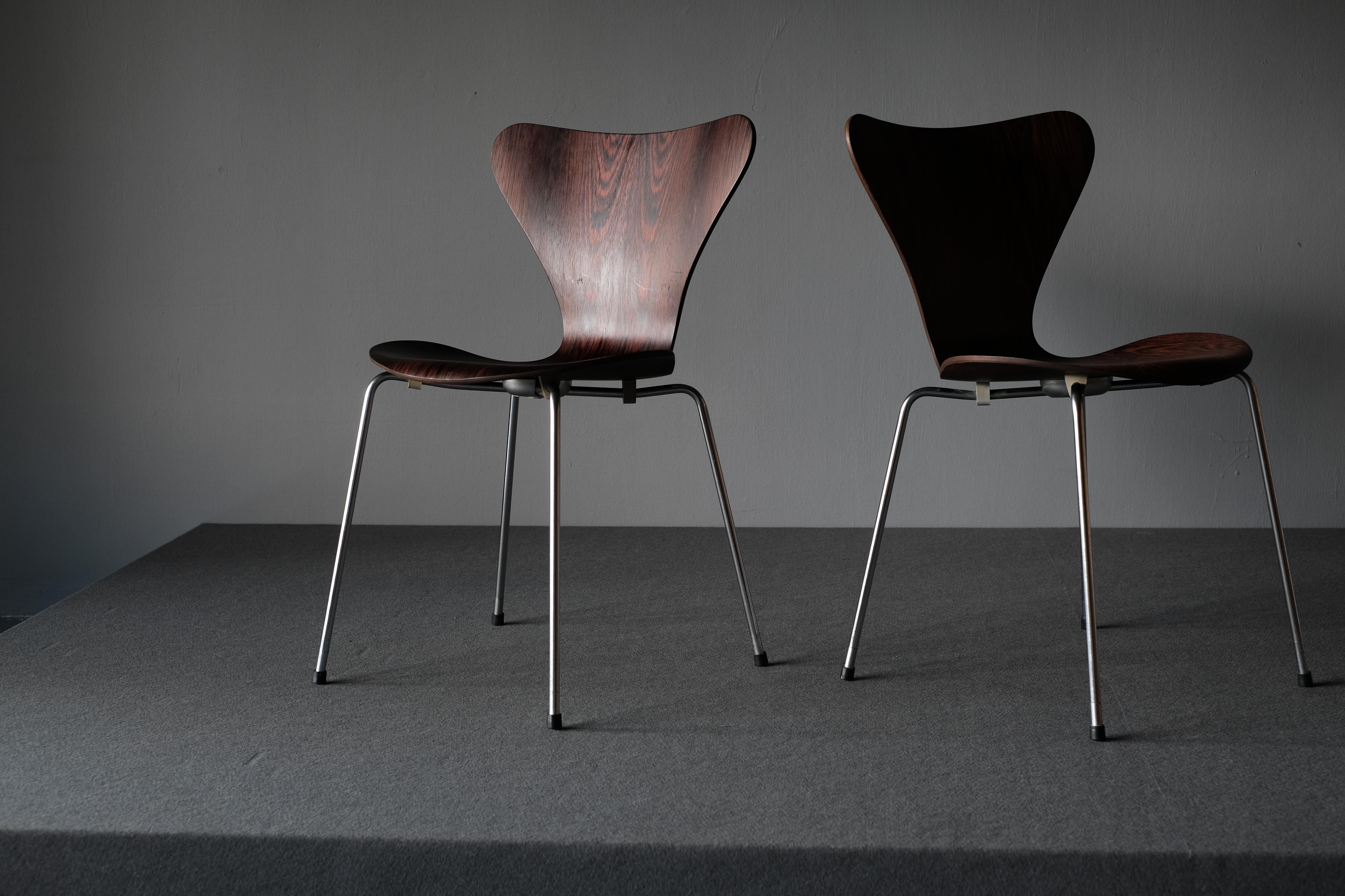 A pair of “Series 7” chairs by Arne Jacobsen. These chairs have a plywood shell with chromium-plated steel legs. They are in Brazillian rosewood with the most amazing grain and patina. Model 3107. Designed in 1955. Manufactured and marked by Fritz