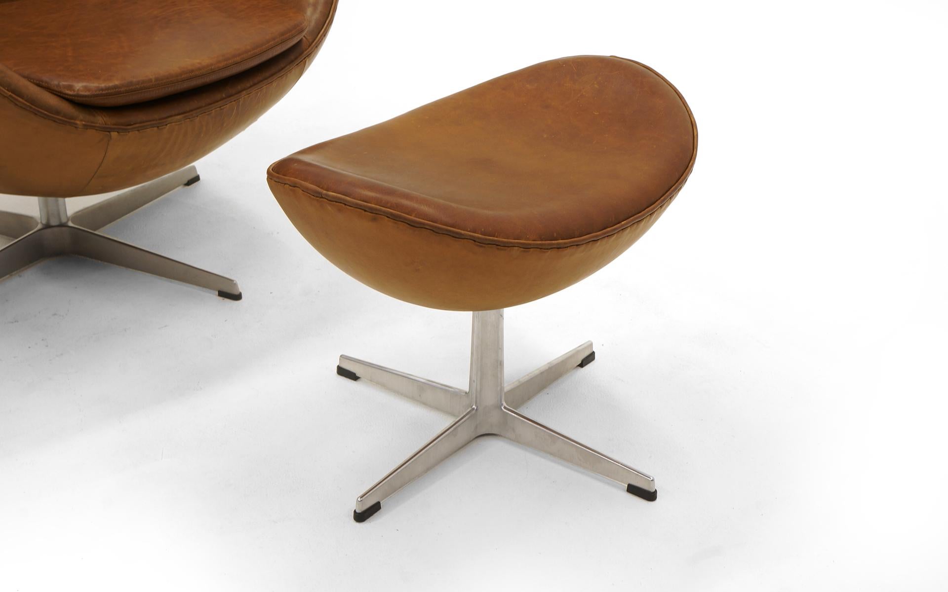 Mid-Century Modern Pair Arne Jacobsen Egg Chairs with Ottomans, Cognac Leather. Price is for all.