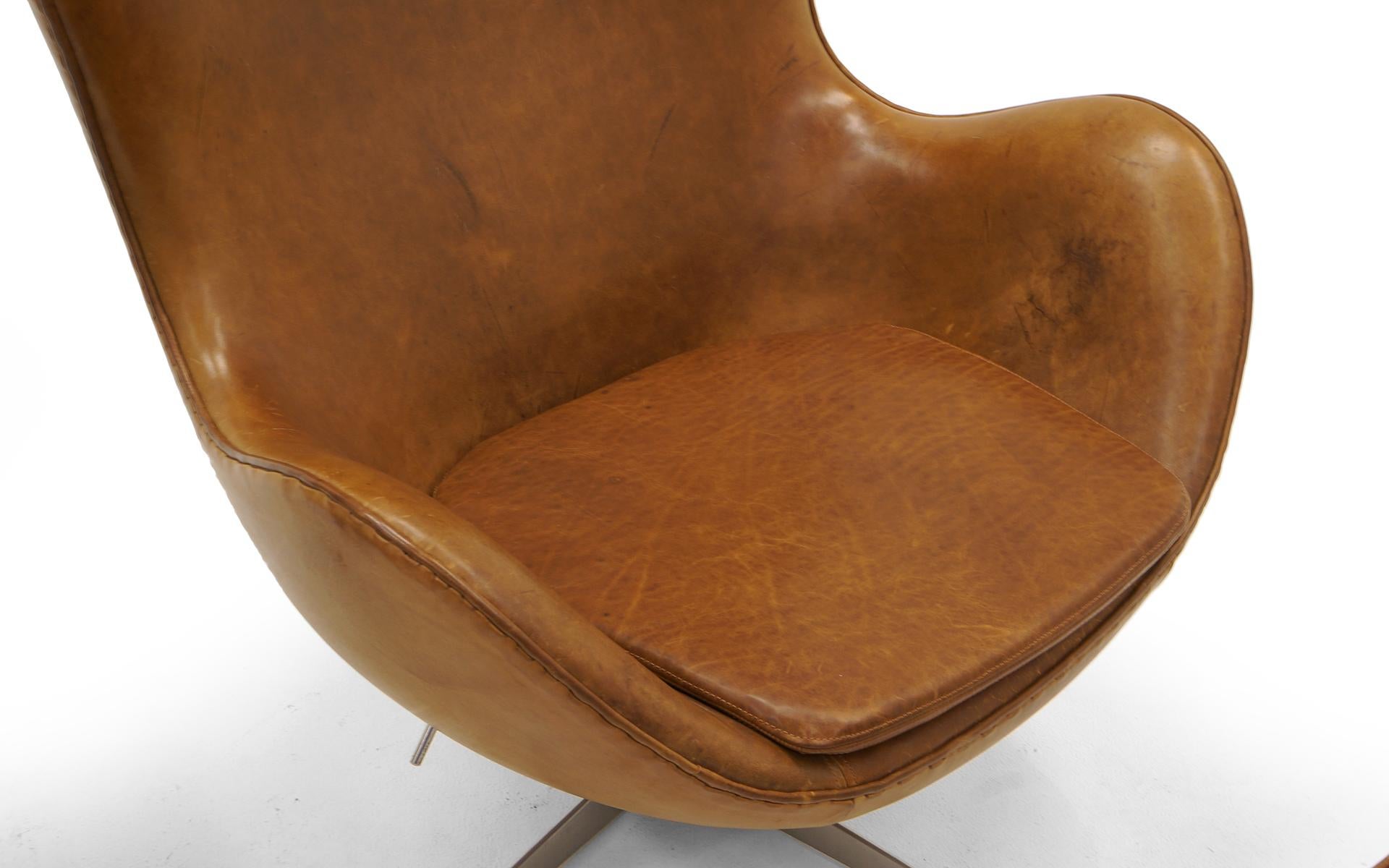 Contemporary Pair Arne Jacobsen Egg Chairs with Ottomans, Cognac Leather. Price is for all.